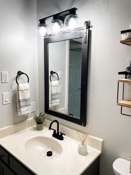 Bathroom vanity mirror and light fixture. Black farmhouse mirror. Farmhouse bathroom decor 

#LTKFind 

#LTKhome