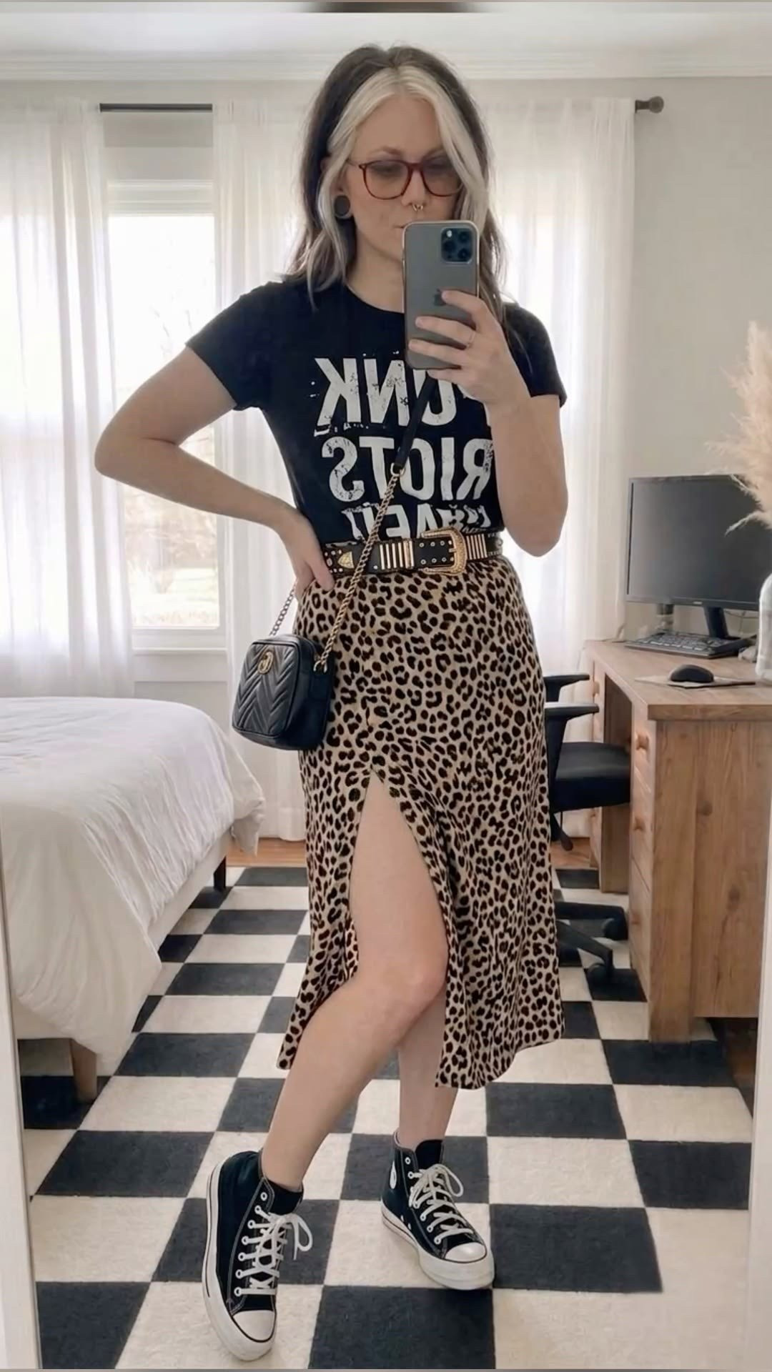 Leopard print is a neutral, change my mind! 🖤 Spicing up the daily uniform with this edgy-meets-casual look. Styling a classic graphic band tee tucked into a high-waisted leopard print midi skirt with a thigh-high slit for the perfect mix of grunge and chic.

Paired it with my absolute go-to black high-top Converse sneakers to keep it comfy and effortless, a quilted black crossbody camera bag, and a statement Western-style studded belt to pull it all together. 🎸✨

This look is perfect for casual date nights, concerts, weekend brunch, or whenever you want to feel a little extra cool.

#LTKootd #LTKSeasonal #LTKMidsize