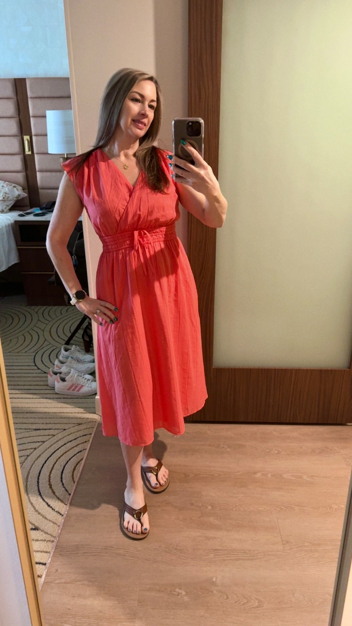This is the perfect spring dress for walking around the parks or sitting in your favorite ice cream shop, like Beaches and Cream at The Beach Club. Coral is one of my favorite colors to wear, and it’s not as easy to find as it used to be. That’s why I grab it whenever I can. With a classic crossover top, a flattering waist, and breezy lightweight material, this dress will get a lot of use throughout the summer months. I also love the subtle large stripe tone-on-tone pattern. 
I'm wearing a size petite 4 and I paired it with my favorite Vionic flip flops to keep it casual. 

#LTKootd #LTKPetite #LTKOver40
