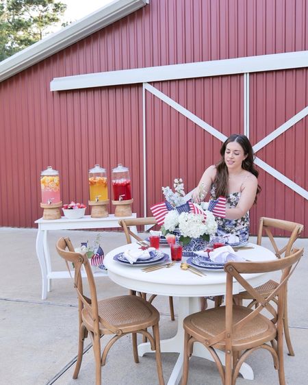 The 4th of July is the perfect time to show your patriotic side with a festive tablescape. Whether you’re hosting a smaller gathering of family and friends or a large party, you can easily create a festive 4th of July tablescape with a few simple decorations. Start by creating red, white, and blue place settings. For this place setting I used the Marlow Thomas dishes from William Sonoma. I also used blue chargers, floral print blue plates and floral appetizer plates in different designs. The appetizer and dinner plates also come in red so you can do an alternating color for a fun and festive colorful look. I opted for gold silverware, which I use frequently, to match the gold around the rim of the dishes.

For a more luxurious touch, opt for cloth napkins. I did a simple white with red edging to give a subtle hint of red and added a nice wow statement with the napkin holder. I found the cutest star-shaped napkin holders on Etsy, and they also come in blue and other designs. You can also embellish the napkins with patriotic charms or ribbons for a special touch.  You can also get creative and match the theme of your tablescape by using napkins with designs that reflect the holiday, such as fireworks, sparklers, or of course stars and stripes. Whatever you choose, make sure to choose napkins that show off your American spirit and give your 4th of July table an added festive touch.

#LTKfamily #LTKunder100 #LTKhome