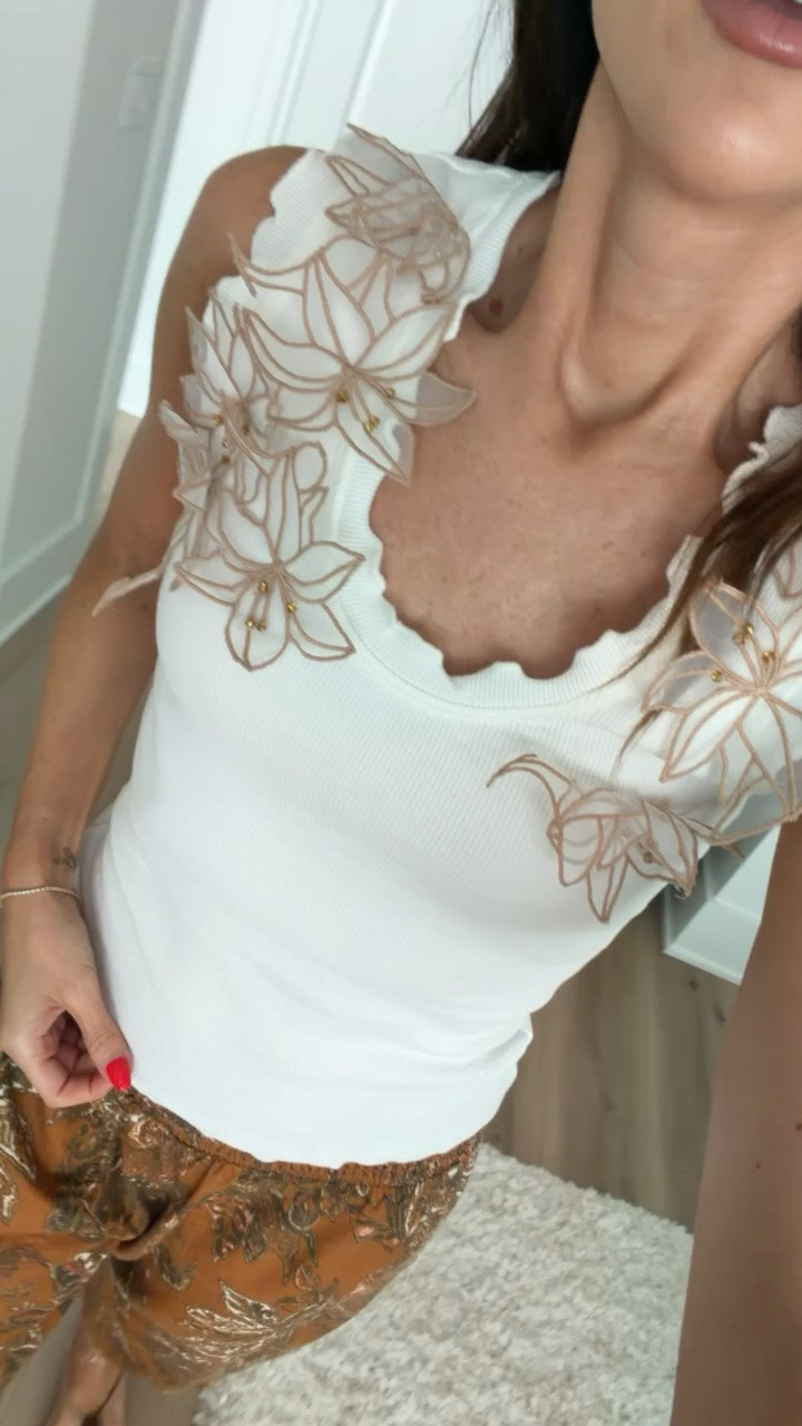 Beautiful floral tank from Anthropologie o major sale for $35.

A romantic summer outfit that pairs a floral appliqué tank with breezy printed pants for an effortlessly chic vacation look.

vacation dinner outfit, European summer style, resort wear look, feminine summer outfit, coastal chic style, printed pants outfit, romantic summer look, vacation ready style, elevated casual outfit, warm weather fashion

#LTKootd #LTKSaleAlert #LTKOver40