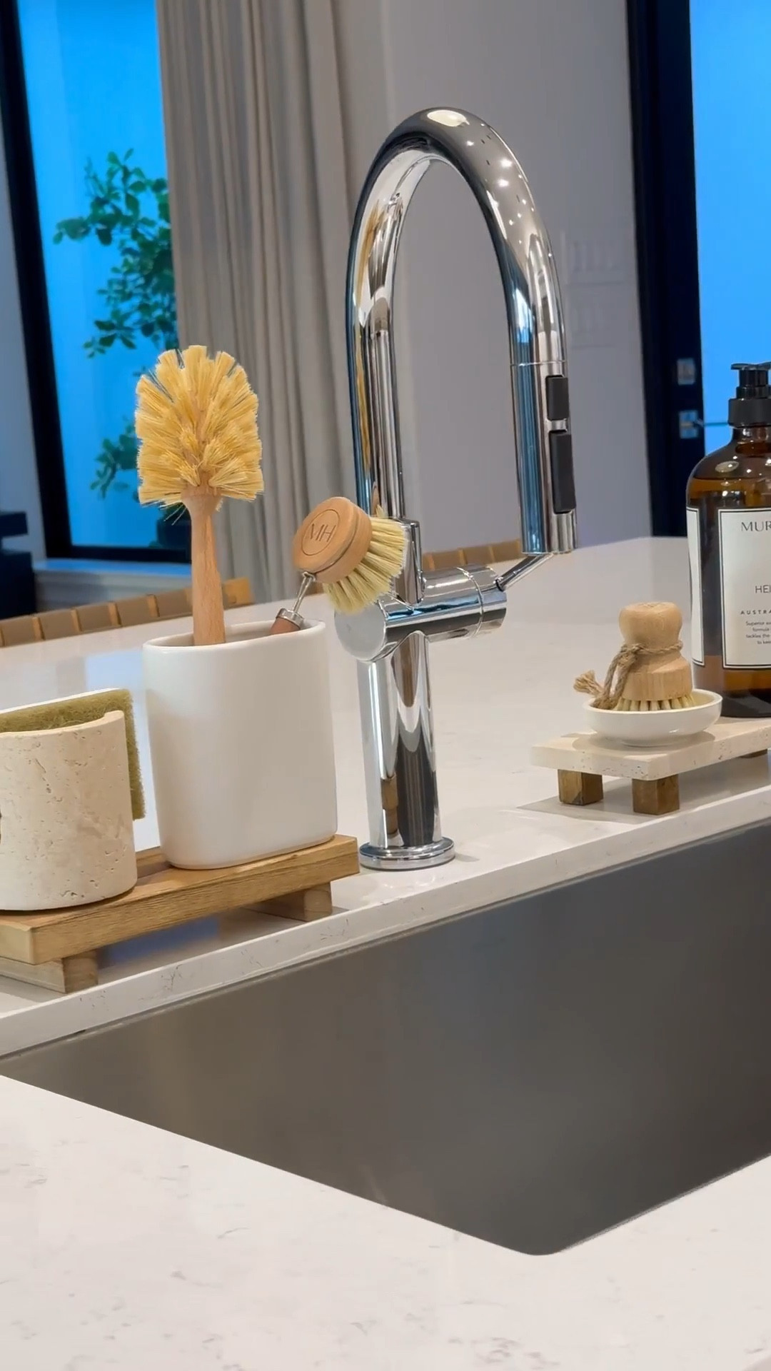 Kitchen Sink Essentials: 

Wooden & travertine risers 
Dish sponge holder 
Brush holders
Glass, pot, and dish brushes
Dish soap 
#LTKStyleTip 

#LTKSaleAlert #LTKHome