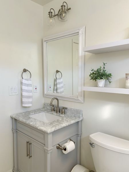 Powder room refresh with a new vanity and shelves.  Love the marble top on this vanity.  

#LTKhome #LTKover40 #LTKfindsunder50
