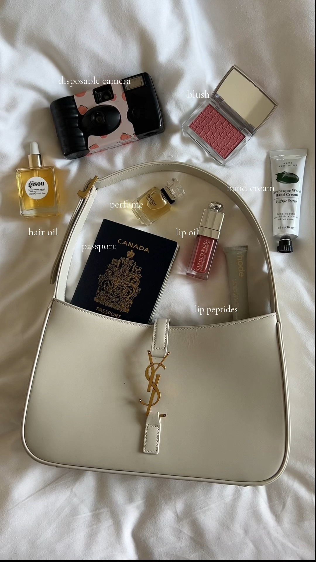 whats in my bag 🎀

- YSL Bag 
- dior lip oil & blush in rosewood 
- hand cream 
- rhode lip 
- passport 
- fave perfume in travel size 
- disposable cam from urban 
- gisou hair oil 

#LTKitbag #LTKVideo #LTKbeauty
