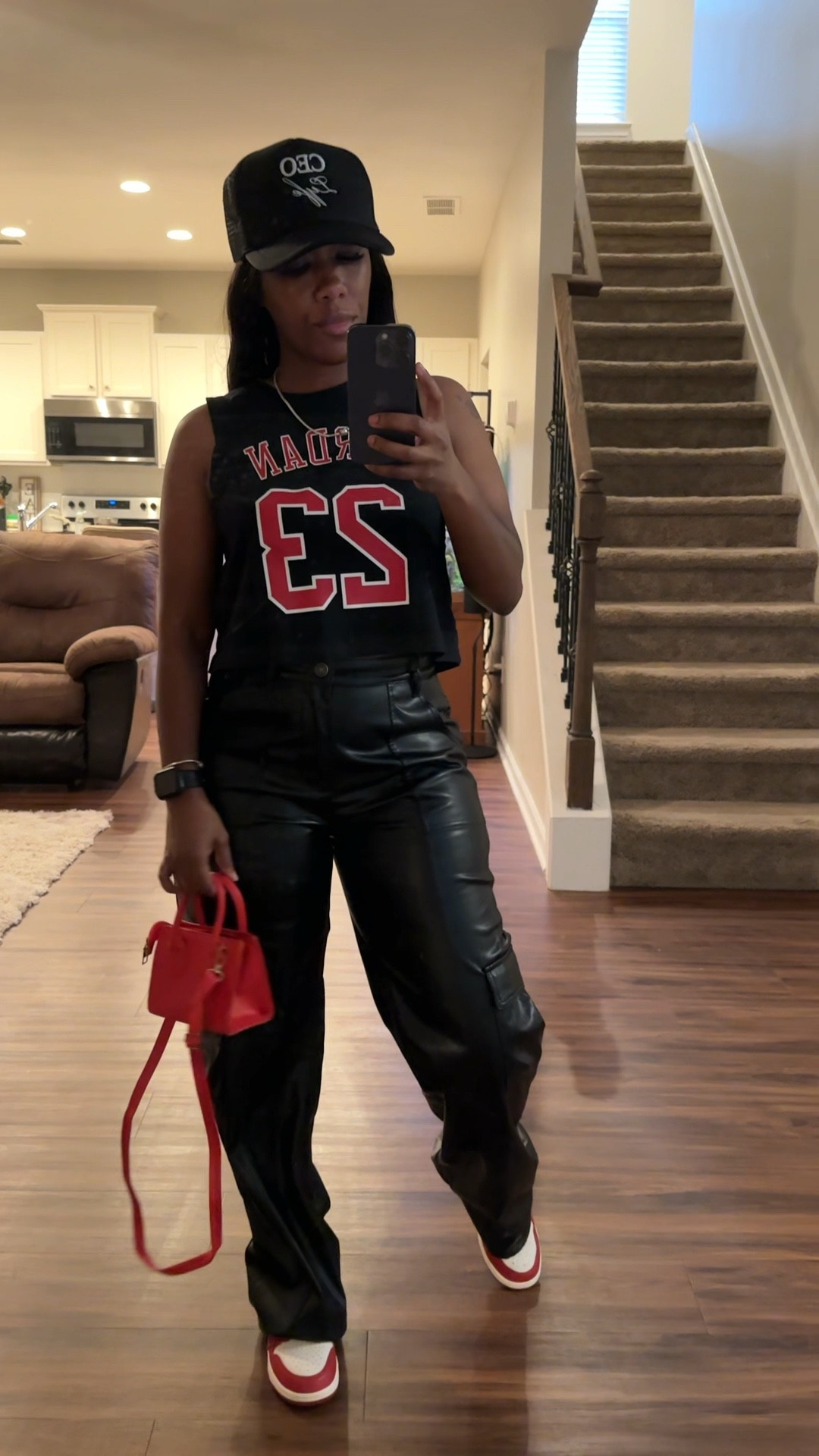 Basketball game outfit. I’m wearing a Jordan sleeveless crop top, black faux leather pants, red purse, black trucker hat, a d Jordan 1 lost and found sneakers 

#LTKStyleTip #LTKShoeCrush #LTKSeasonal