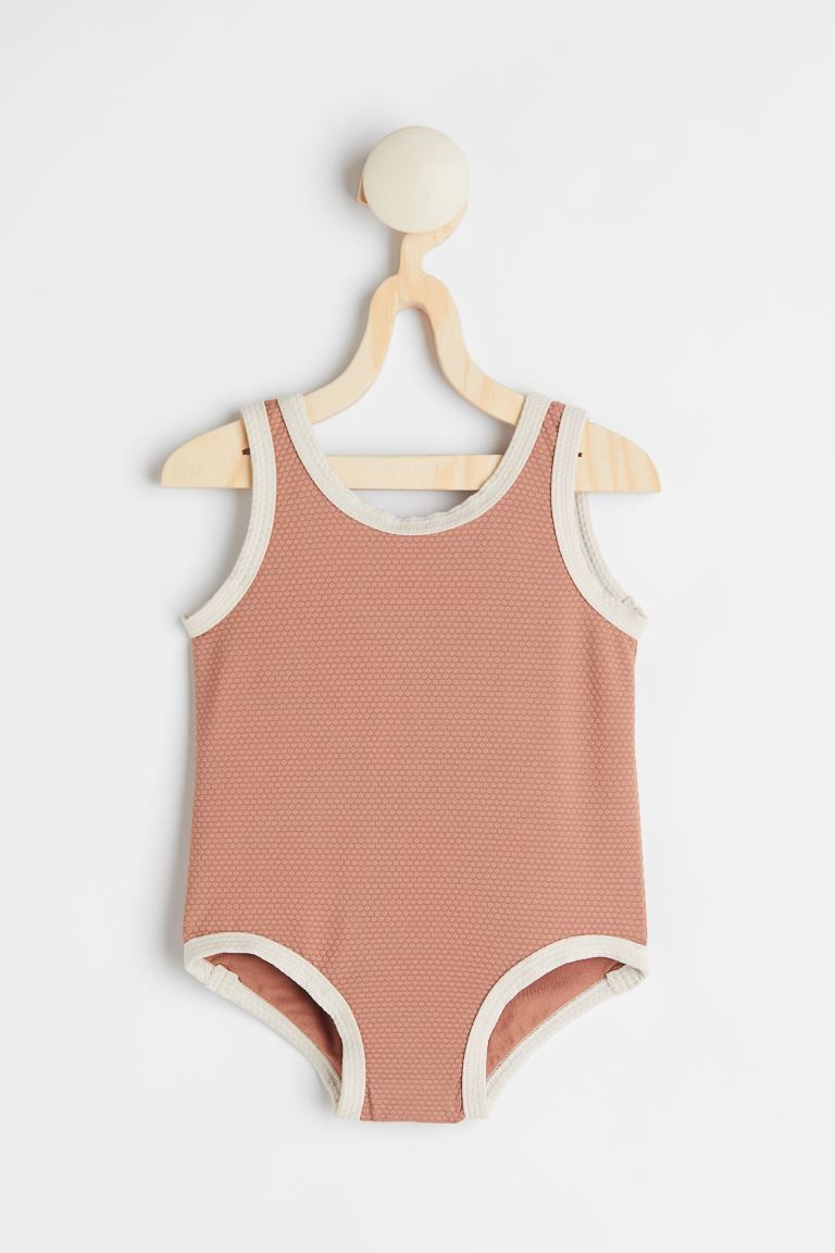 Baby Exclusive. Fully lined swimsuit with contrasting piping. Slightly lower-cut neckline at back... | H&M (US + CA)
