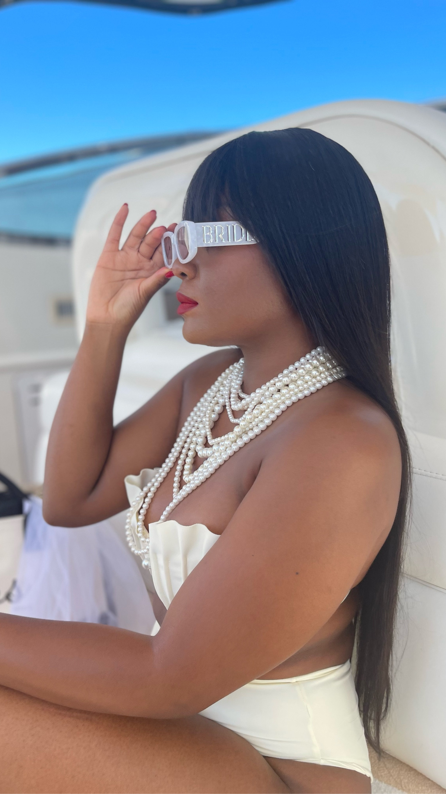 Bridal fashion on a whole new level for my bachelorette yacht day! 🤍✨ Rocking a chic white swimsuit adorned with pearls, paired with bold red lips and matching red nails for a striking contrast. The perfect mix of bridal elegance and yacht party vibes! Whether you're celebrating at sea or by the beach, this look is all about feeling confident and glamorous. Brides-to-be, don't be afraid to add a pop of color to your bachelorette look! 💄⛵ #BridalFashion #BacheloretteStyle #YachtVibes #RedLipsBridal #BoldBridalLook #SummerBride 

#LTKSwim #LTKWedding
