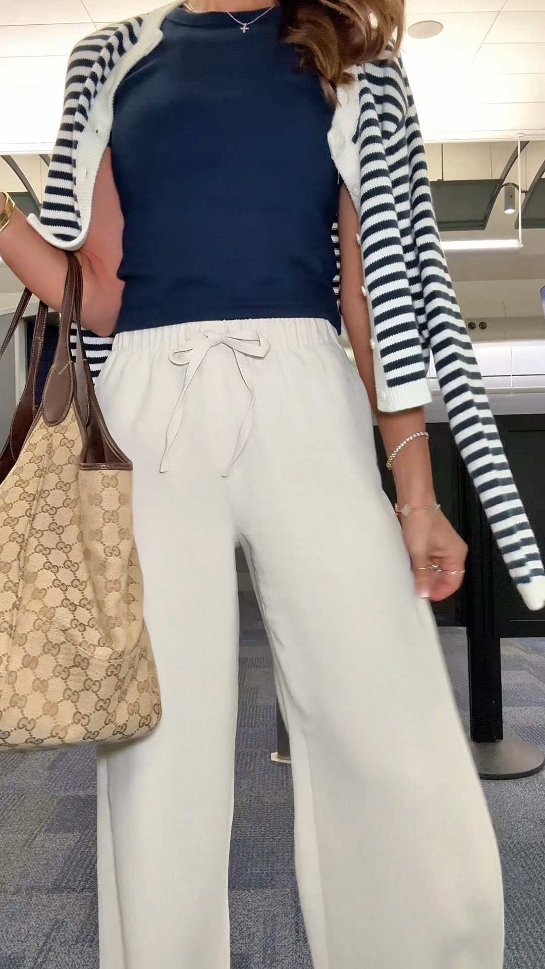 My travel outfit of the day! Aritzia The Lodge Pant - Crepette. Size XS regular, color ‘Metropolis Taupe’. Comes in short and tall, too. Wrinkle resistant with an elastic waist and high-rise. Aritzia t-shirt in XS. Aritzia striped cropped cardigan in 2XS. Jelly ballet flats are whole sizes only. I’m a 6.5 and sized down to a 6 per reviews. Business casual. Elevated casual. Workwear. Coastal outfit.

#LTKTravel #LTKPetite #LTKootd