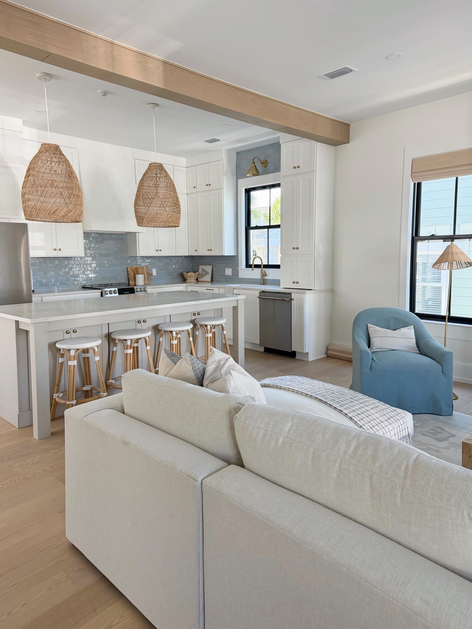 Beach house living room 🏡

Rug is a similar option. Swivel chair is Seaglass. Pendants are the larger size. Floors are Anderson Tuftex European Ash. Window treatments were local.