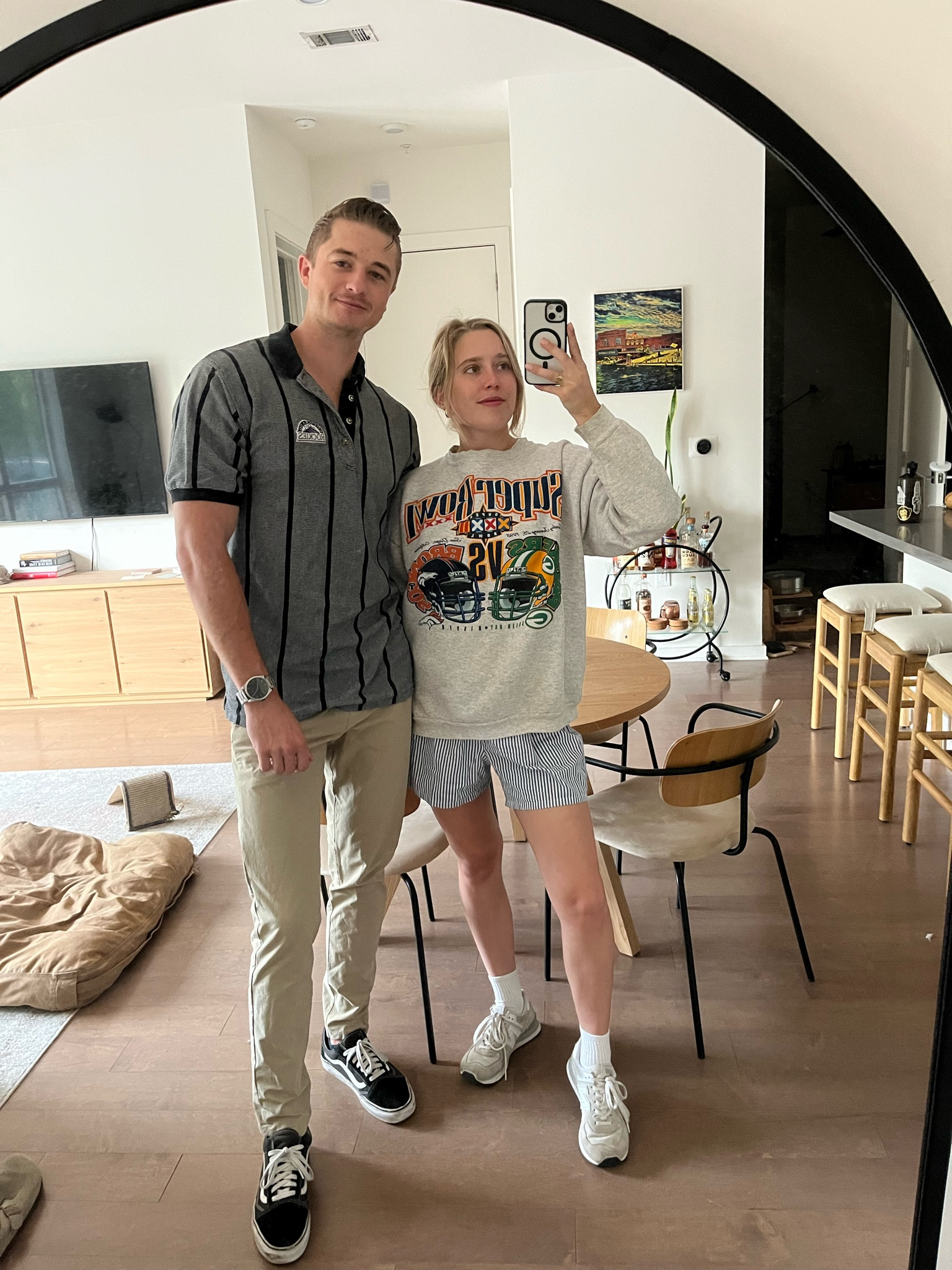 Mal top to bottom
Sweatshirt: Vintage Super Bowl sweatshirt (Etsy is the best to find it)
Shorts: J.crew
Shoes: New Balance

Brian 
Top: Vintage Rockies Polo
Pants: lulu abc pants
Shoes: vans