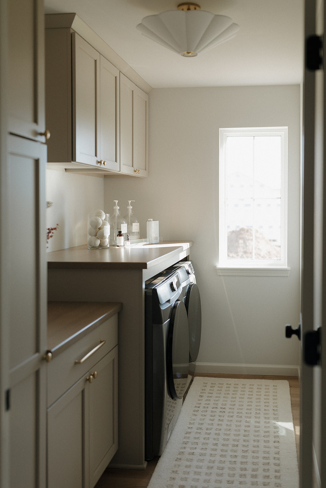 Shop everything in our laundry room! // Wall Color: First Star by Sherwin Williams // Flooring: Coretec LVP in Springfield Oak  // Cabinets: Custom by Countryside Cabinets in Oyster (Cabinets) and North Pier (Countertop)  

 #LTKHome