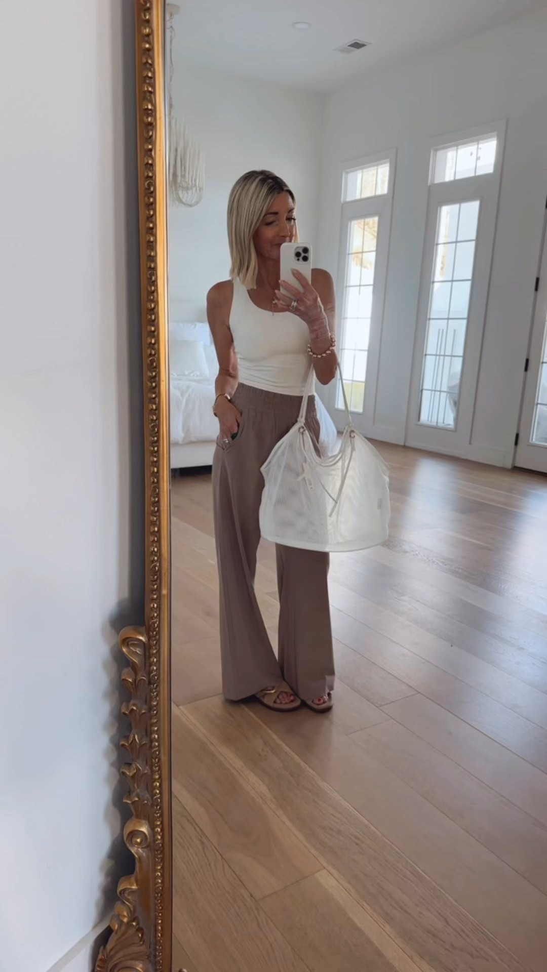 You will want this ootd for your next beach trip !!! It has it all, comfort, style & classy !!! These pants are viral for a reason , thin for summer , stretchy waist band pockets & the wide leg 😍… wearing XS … Butter soft tank , these sandals are so good and definitely worth a try …Ivory mesh bag with the gold detail !!! Yes please !!! 

#LTKTravel #LTKOver40 #LTKootd