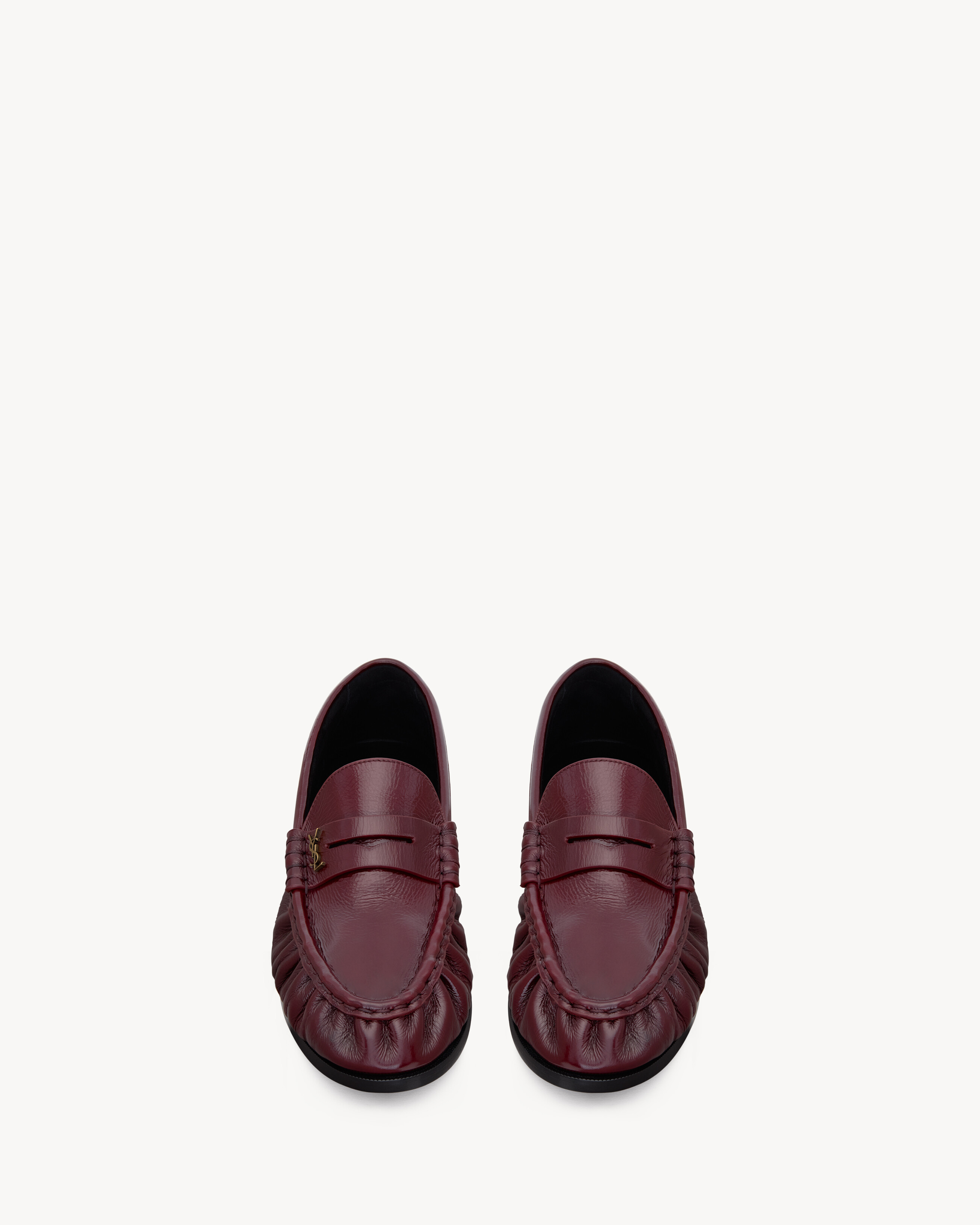 supple penny loafers decorated with the CASSANDRE, featuring a hand-stitched moc toe. | Saint Laurent Inc. (Global)