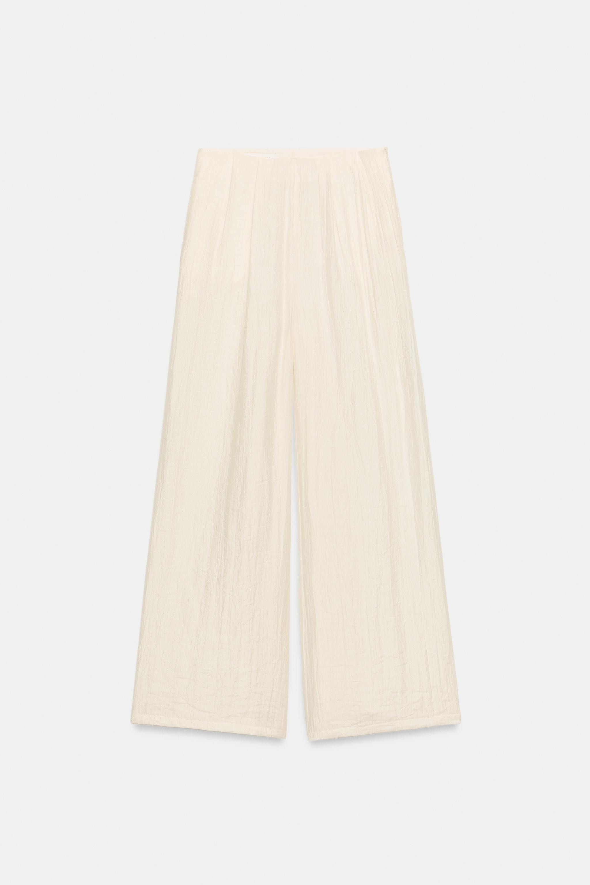 Model height: 181 cmHigh-waist trousers with pleats and front pockets. Wide-leg fit. Invisible si... | Zara FR