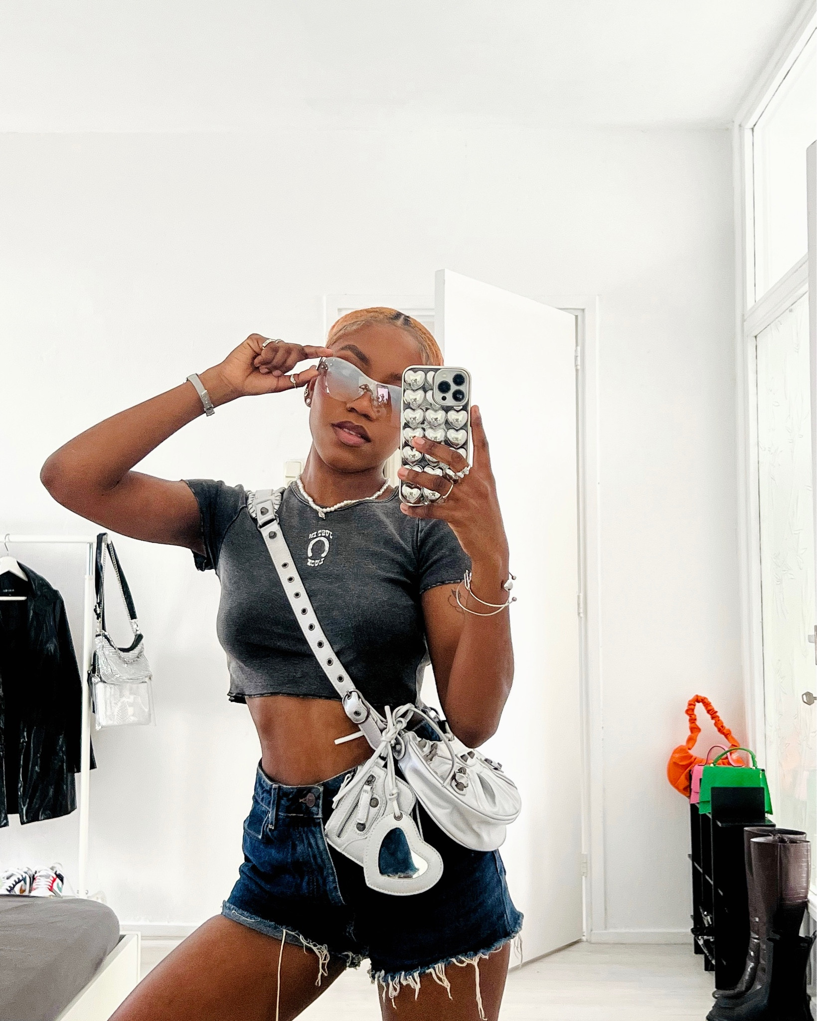 An all silver look, including a SHEIN heart metallic silver phone case, and silver accessories. Diving into that Y2K aesthetic with these TikTok trending silver Y2K H&M sunglasses. Paired with a simple denim wash H&M crop top & a silver Balenciaga Le Cagole dupe bag. 

#LTKstyletip #LTKunder50 #LTKeurope