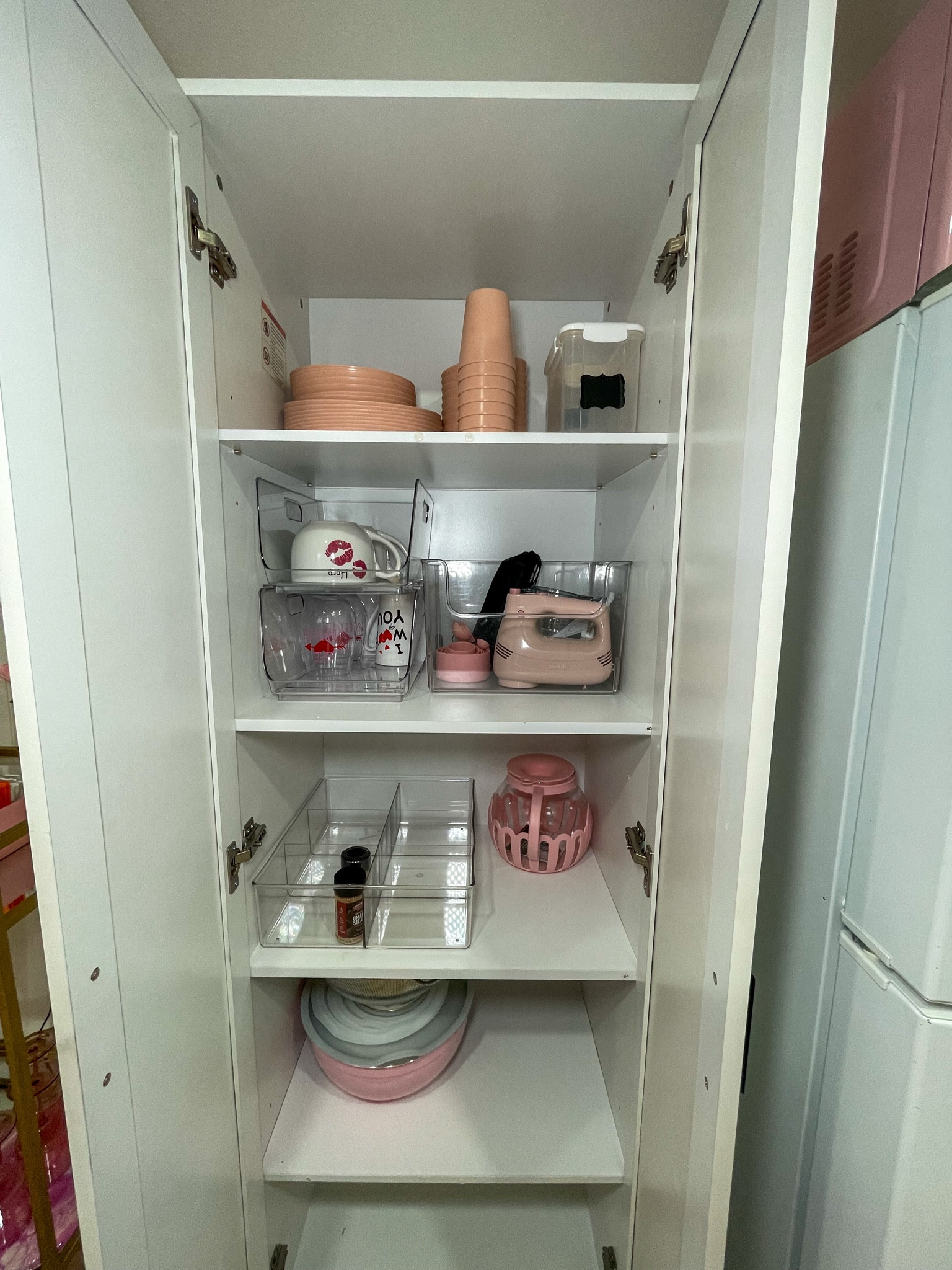 Perfectly organized kitchen cabinet — small space, big functionality.