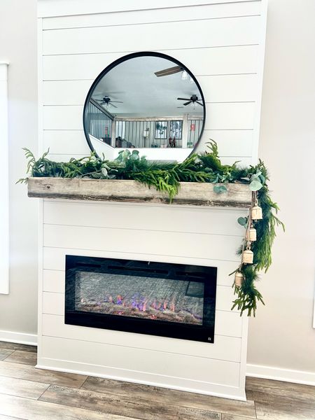 Winter mantel with electric fireplace insert, round mirror and garland

#LTKhome #LTKSeasonal