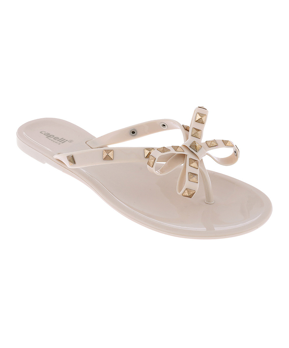 Capelli New York Women's Flip-Flops Nude - Nude Studded Bow Jelly Sandal - Women | Zulily
