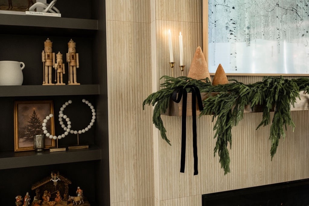 A close-up of the coziest Christmas moment 🎄🕯️ Layered cedar garland, taper candles, natural wood trees, and minimal festive accents make this mantel feel warm and timeless. Beautiful inspo for holiday shelf styling, Christmas mantel decor, neutral winter home decor, organic Christmas decorating, and classic holiday home inspiration.

#LTKHoliday #LTKSeasonal #LTKHome
