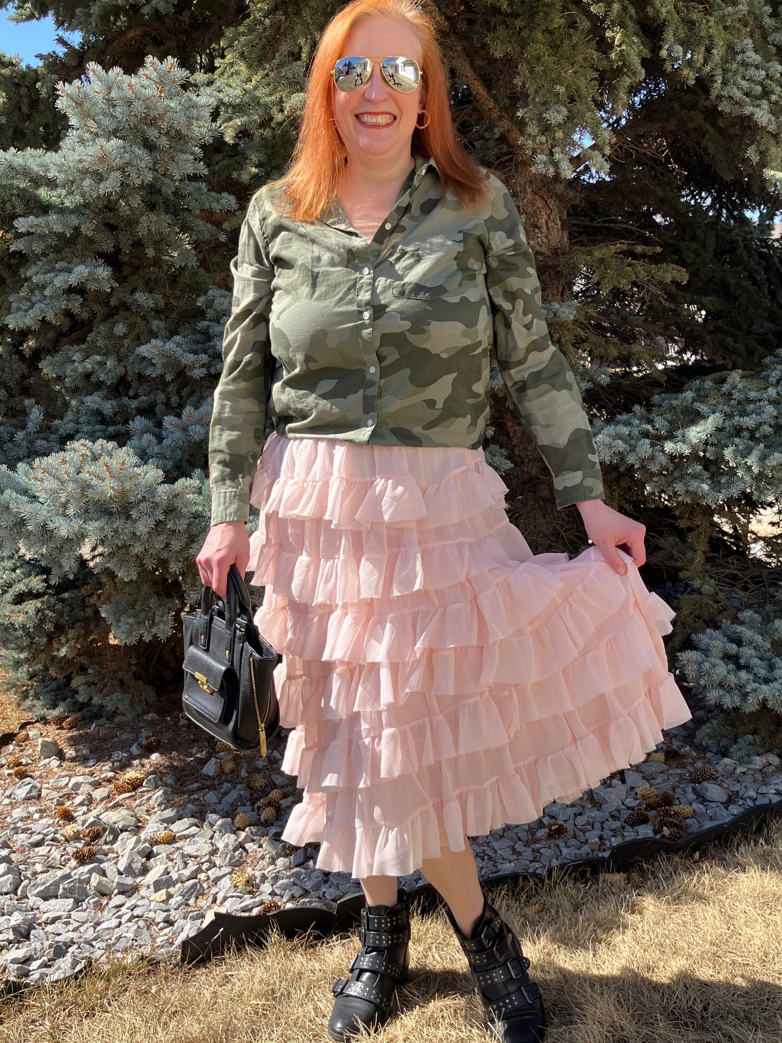 Camo and pink frilly skirt? Rock the casbah!! Who says Mondays have to be blah? I wanted a look that was rocker chic so I paired my camo blouse with my pink ruffled skirt. I loved adding my studded boots, aviators, and my fav black bag. Would this outfit snap you out of a boring Monday? It sure worked for me! Canadians click on the first links to shop, and Americans click on the second links to shop. If there’s only one link then you can shop it in your own country. And remember, trendy doesn’t have to be expensive! Bye!

#LTKootd #LTKOver40 #LTKFestival
