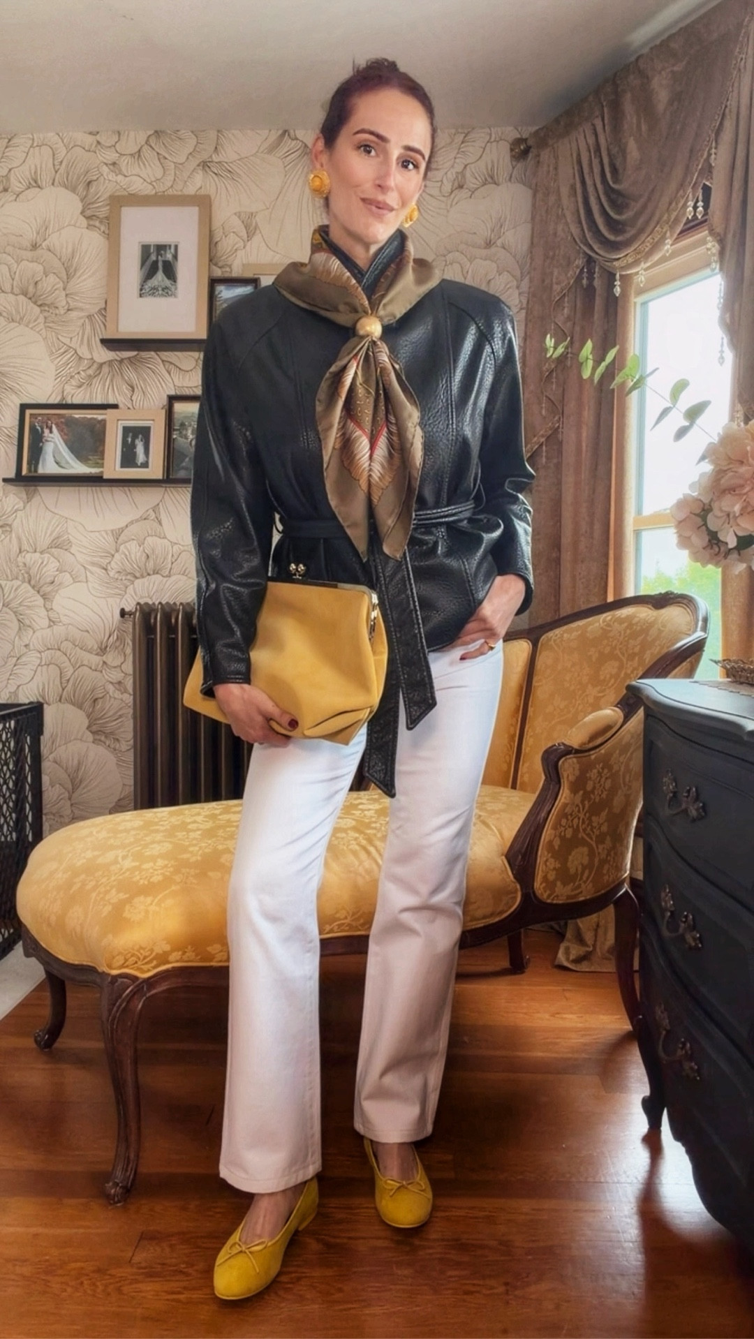 A masterclass in polished, vintage-inspired spring styling ✨ This look is all about intentional contrast—pairing a structured black leather jacket with soft white trousers for that effortless high-low balance. The silk scarf adds a refined, Parisian touch (and doubles as a statement accessory), while the mustard yellow flats and matching clutch bring in a warm pop of color that feels fresh for the season.

This is your go-to formula for elevating everyday pieces: neutral base + texture + one standout accessory moment.

Perfect for brunch, casual meetings, or a day out when you want to feel put-together without trying too hard.