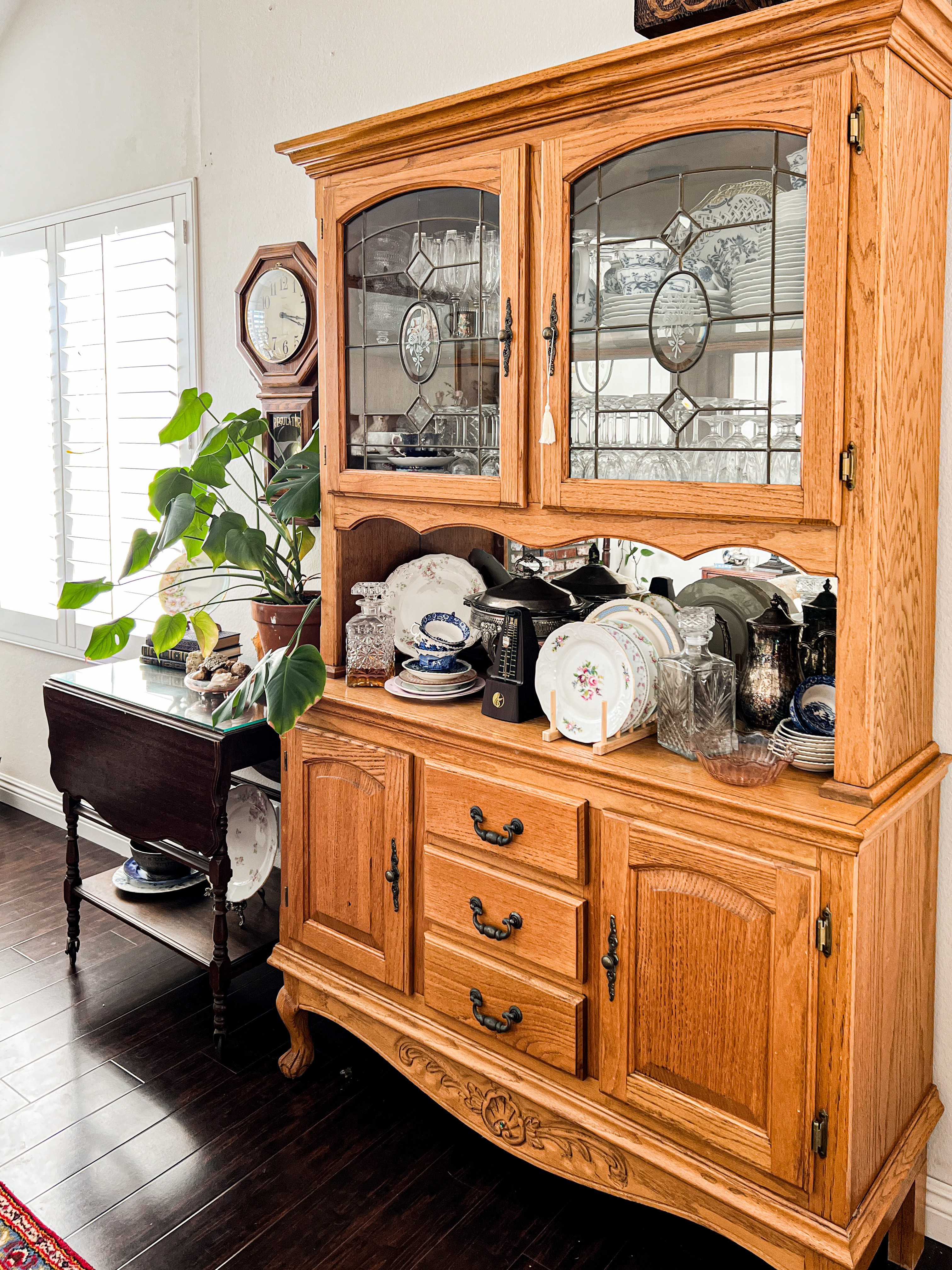 A vintage china hutch full of vintage teacups and vintage plates. They're just waiting for the next tea party. 

 #LTKHome #LTKFindsUnder50 #LTKFindsUnder100