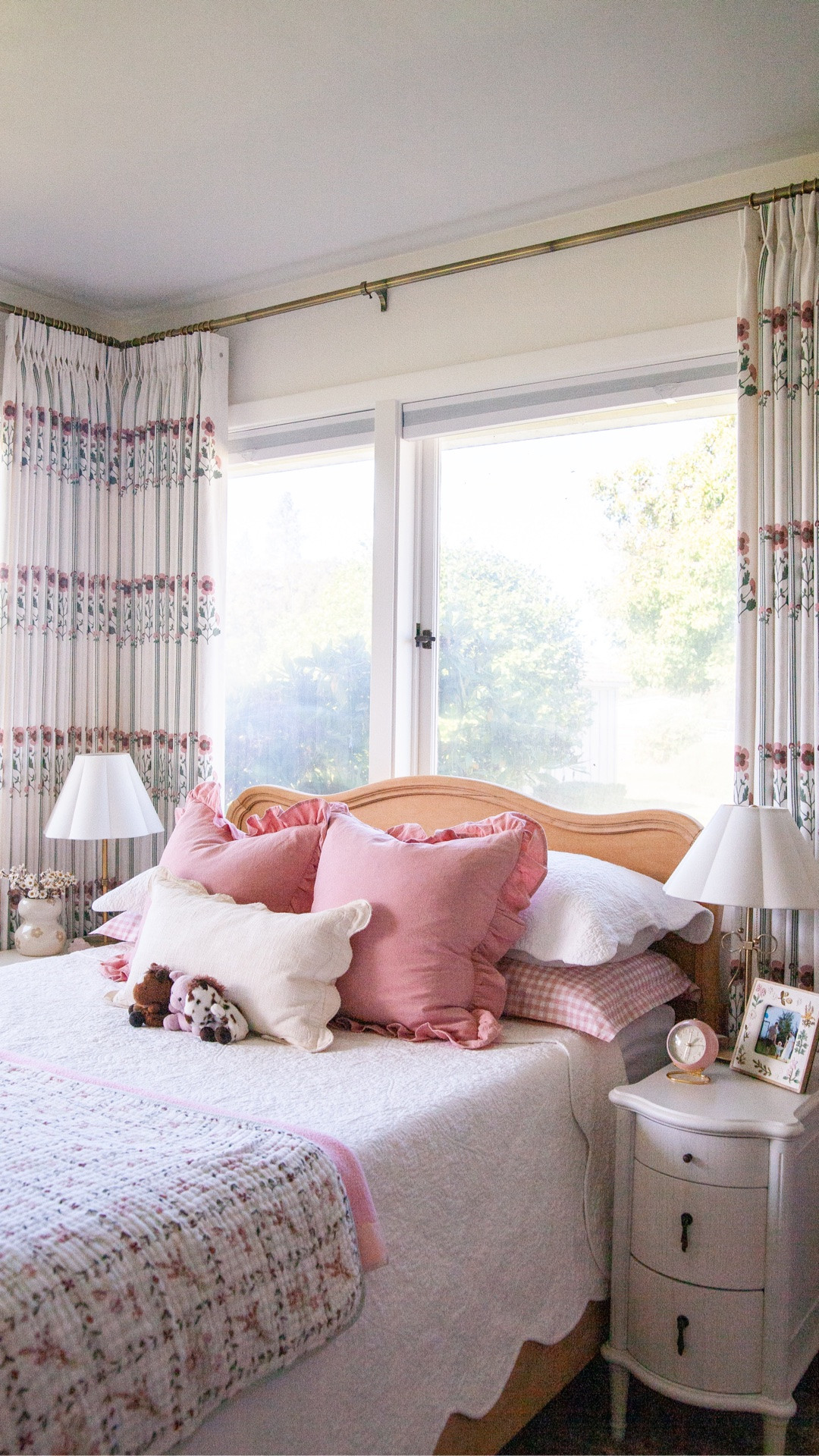 My wonderful friend and her family have been through more than I can imagine the past several years and have recently moved into what was her grandparents’ home. She’s doing an amazing job creating a beautiful, comfortable home for her family but I wanted to help with her daughter’s room. This sweet and very spunky five-year-old girl has been through months of the most intensive chemo, radiation, and two bone marrow transplants and is now healthy and vibrant.

I knew the perfect source for curtains for her room: @threegirlscurtains has so many pretty florals and patterned fabric options for their curtains, and we were able to customize the size and header style, etc. Corner windows like this are often funky to dress, and you typically don’t want to cover any of the window with the curtains are open, but it was unavoidable here… But I think it turned out great! (These are the Lily Vine Floral curtain.) We also tied in the pink with an adorable gingham curtain (the Scottish Gingham) also from @threegirlscurtains on the closet. Their curtains come pre-washed and I chose trained for the pleated ones! ￼

We found these cute solid wood nightstands in a great narrow size from @stosense_home. They have USB plugs and came fully assembled, huge plus!!

Also just found a great source for affordable 100% cotton quilt sets: @evergraceliving, how cute is this scallop here?!

My friend’s home is full of vintage pieces and family heirlooms and this room is no different, like this painted box that was her grandma’s and this wool rug that was in her grandma’s attic bedroom when she was a little girl in Idaho. I love how we mixed girly touches, vintage, and clean, fresh modern sensibility in here.

It is perfect that this is the first room in the house to be finished, this little girl deserves her own space that’s ready for her so much!

#LTKHome #LTKmomlife #LTKKids