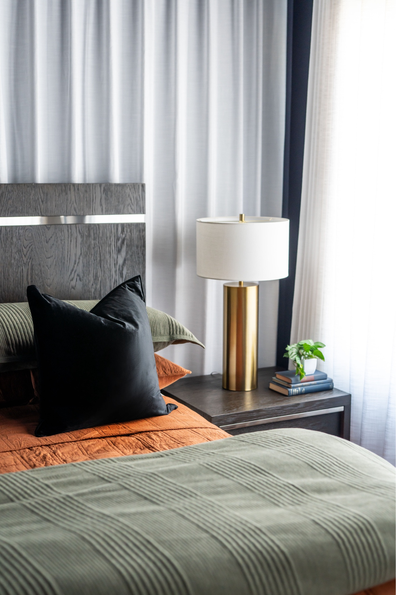 Colorful bedding in dark and moody bedroom with white linen curtains 

#LTKHome