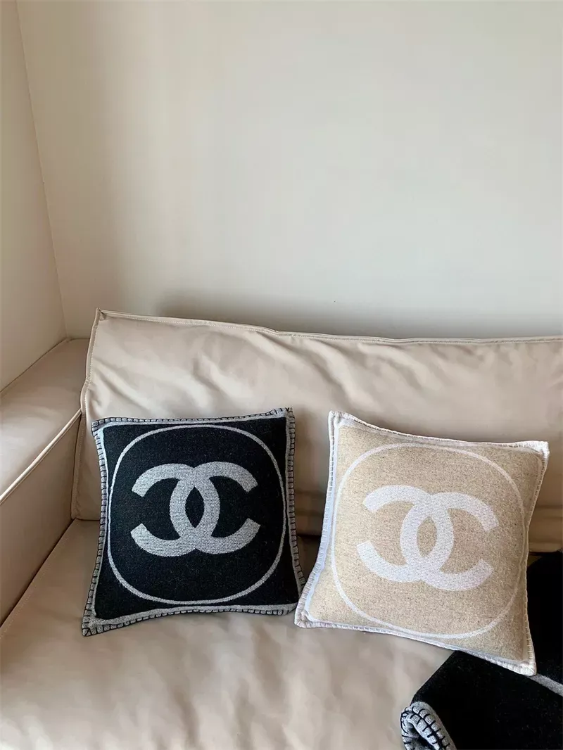 A SET OF TWO IVORY & BEIGE WOOL THROW PILLOWS, CHANEL, 2017