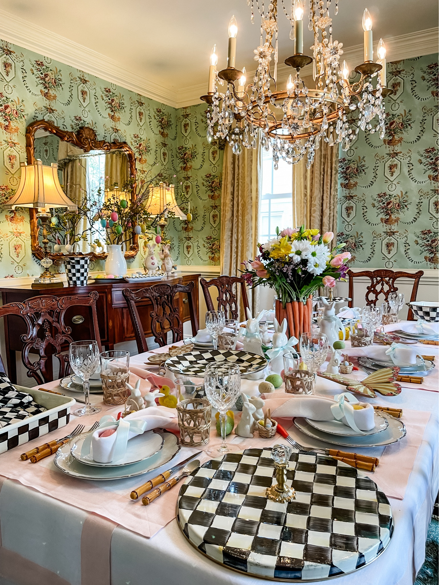Your outpouring of love for my floral carrot arrangement has truly warmed my heart, and I'm thrilled to share more glimpses of this cherished tablescape with you! This setup from last Easter remains a personal favorite, beginning with the charming pink and white table linens that set the stage. The centerpiece? A glass vase, ingeniously lined with carrots and brimming with vibrant flowers from the local grocery, creating an unforgettable visual feast. Accompanying this are whimsical white ceramic bunnies adorned with green bows, and a sprinkle of pastel eggs that add a playful touch to the ensemble. Each place setting is thoughtfully arranged with vintage white china plates, crystal glasses, rattan holders, and bamboo flatware, all tied together with a white napkin and a ribbon bow for that extra dash of elegance. And let's not forget the Mackenzie Childs serveware adding that final flourish (this isn't an ad, just love!). What do you think? As we welcome the spring season, whether you're planning an Easter gathering or any springtime celebration, I hope this tablescape sparks some joy and inspiration for your own festive creations. Let's make this spring unforgettable!
🐰🥕💐🏁🪺🐇🤗
#southernlivingmag #southernladymagazine #betterhomesandgarden #springtablescape #targetdollarspotfinds #grandmillennialdecor #slhome #diningroominspo #springtable #entertainathome #mytradhome #vintagehome #classicdecor #timelessdesign #charminghome #classicinterior #traditionalinterior #seasonaldecor #mysouthernliving #southerninteriors #eastertablecape #classichome #traditionalhome #myhousebeautiful #postitandsmile #diningtabledecor #setthetable #entertainandcelebrate #southernliving

#LTKhome #LTKstyletip #LTKSeasonal