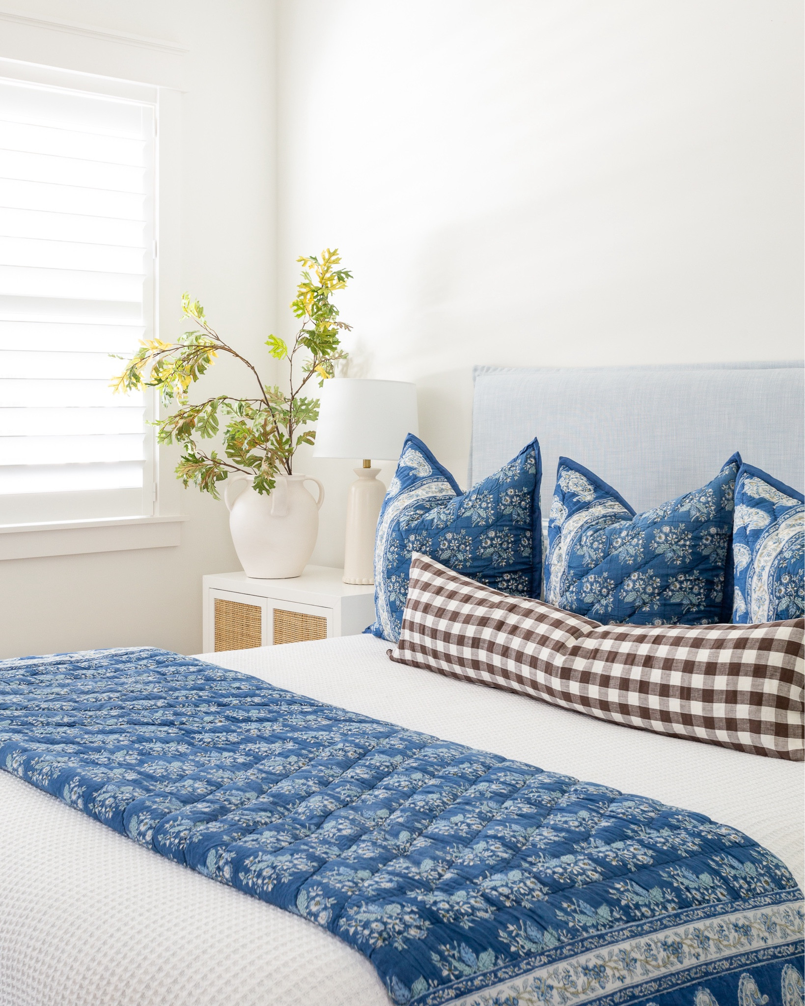 Our bedroom decorated for fall with our light but upholstered bed (also
linking a look for less), faux pale leaves, white vase, rattan nightstand, blue paisley quilt and pillows, gingham lumbar pillow, and texture white blanket. #ltkhome #ltkseasonal #ltksalealert #ltkfindsunder100 #ltkstyletip #ltkfindsunder50 #ltlvideo

#LTKHome #LTKSeasonal #LTKSaleAlert