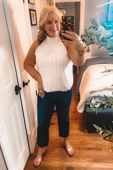 I am so loving this halter top! Creamy white with thin metallic stripes.
It’s runs true to size, I went up though because I wanted this to have a larger, more bohemian type fit. 
I love how versatile this is. Pair it with tan shorts for a casual, day look. Pair it with a pair of fitted black pants for a date night look. I styled it here with my favorite pair of dark wash denim for something in between 😉.
Right now, it’s 40% off!
Summer outfits, denim, jeans, casual outfits, Tory Burch, sandals, flip flops 

#LTKSaleAlert #LTKOver40 #LTKMidsize