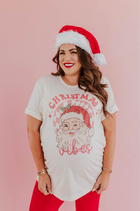 curvy Christmas Vibes graphic tee! part of my Merry Pinkmas collection with Pink Desert! i’m in the xxl, typically would take the large not pregnant. runs TTS!  🩷

wearing size xxl in red ribbed pants, normally a large 

#LTKHoliday #LTKmidsize #LTKfindsunder100