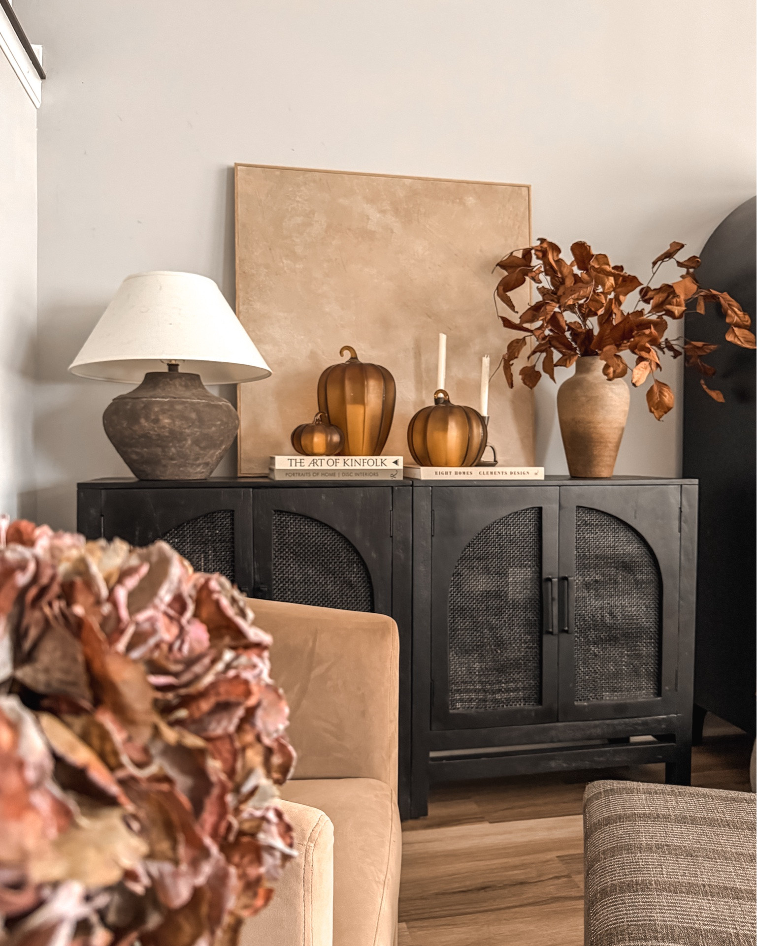 This side of the living room has become a space I can’t stop looking at 😍

Fall living room decor, cozy fall home, fall living room styling, autumn home decor, cozy autumn decor, neutral fall decor, elevated fall decor, vintage inspired fall decor, warm neutral home, moody fall decor, cozy living room ideas, fall decorating ideas, autumn living room, fall home inspiration, cozy home styling, vintage inspired home, traditional fall decor, earthy fall decor, brown fall decor, amber glass pumpkins, glass pumpkin decor, fall floral arrangement, dried hydrangea decor, moody hydrangeas, burgundy fall florals, fall stems, autumn flower arrangement, vintage vase styling, olive green vase, accent chair styling, cozy reading corner, living room corner decor, side table styling, console cabinet styling, fall console table decor, layered fall decor, warm wood tones, collected home decor, organic modern decor, cozy vintage decor, cottage inspired decor

#LTKHome #LTKSeasonal