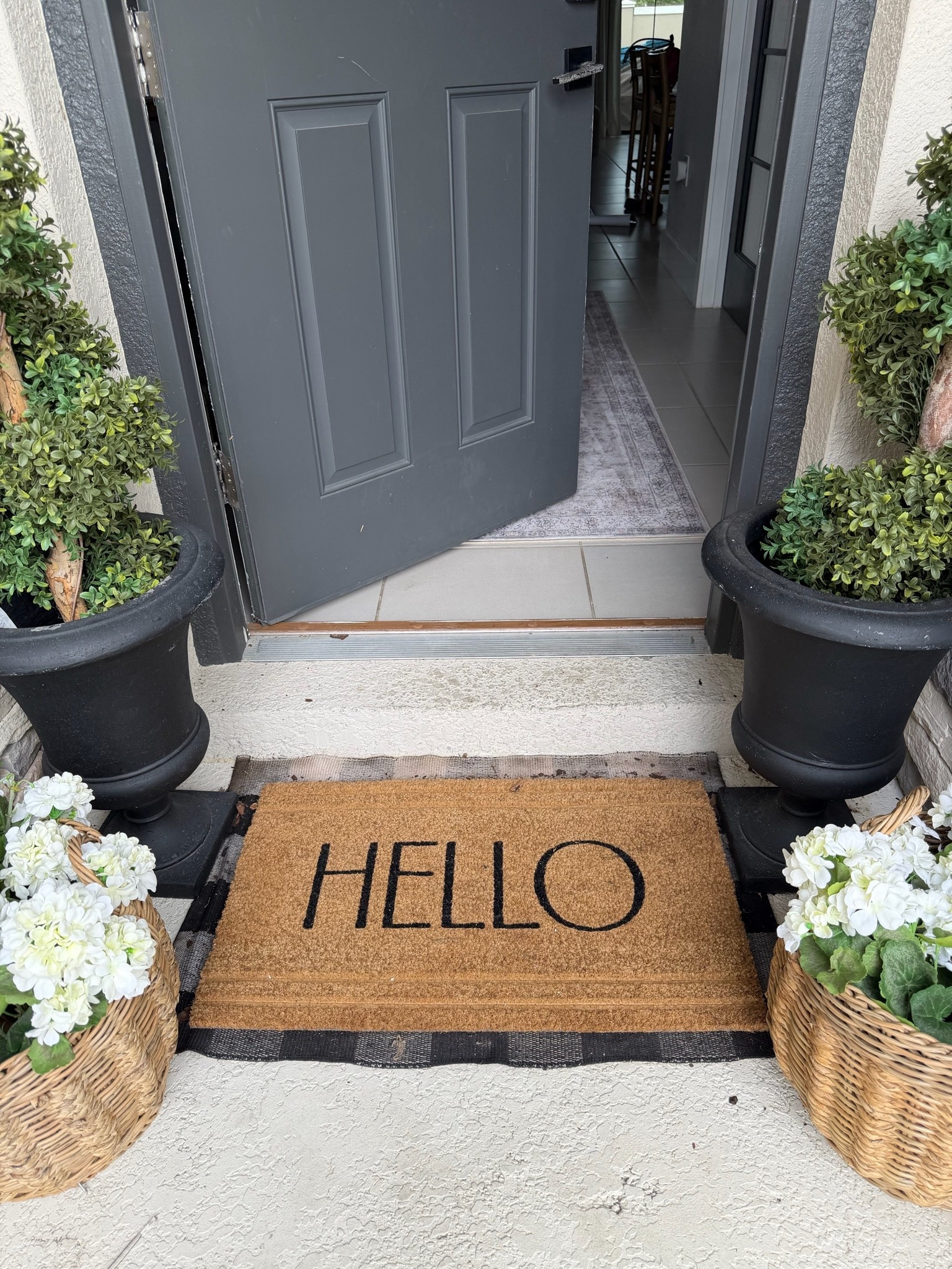 Front porch hello mat with faux trees and faux flowers slowly transitioning to fall

#LTKHome