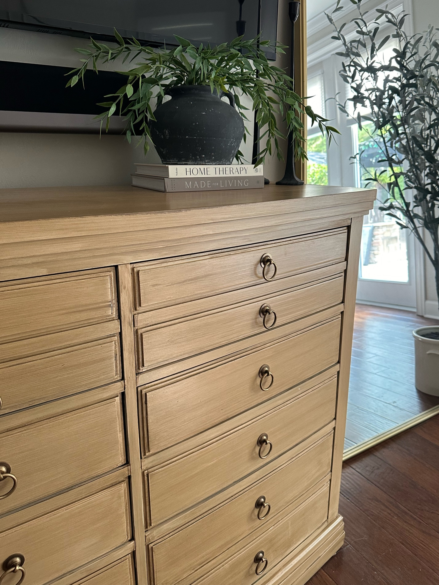 Pottery Barn dresser look for less makeover using Retique It. Paired with black urn vase and stems stacked on books with candle stick holders, viral Olive tree and oversized gold floor mirror  

#LTKHome #LTKFindsUnder100 #LTKSaleAlert