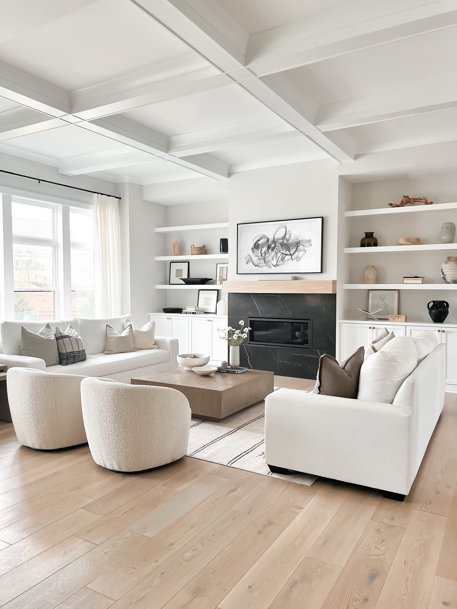 Home decor, living room, side table, Boucle chair, area rug, white sofa, square coffee table, shelf decor, throw pillow, patterned rug, faux floral, frame tv

#LTKhome #LTKFind