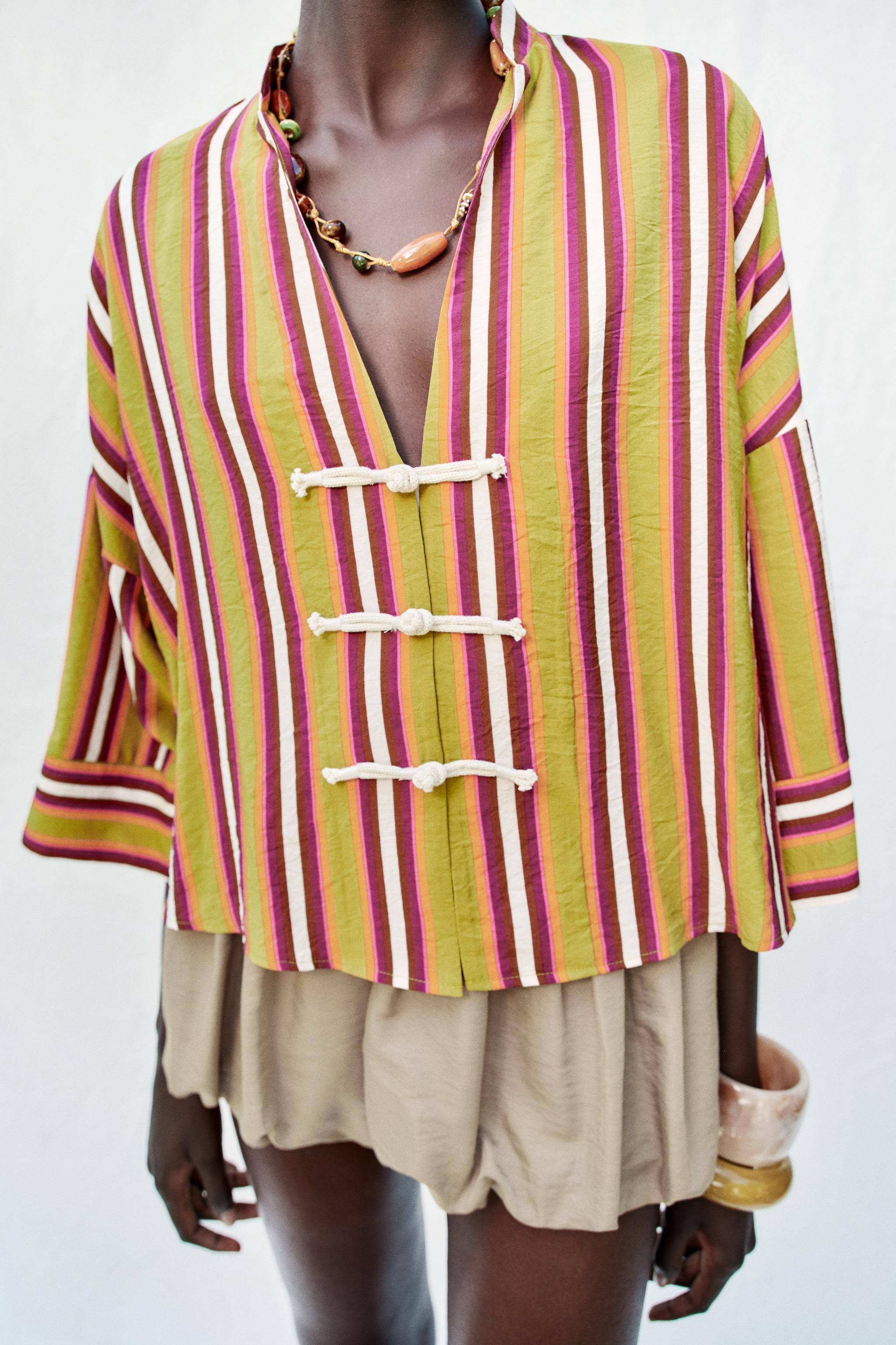 Round neck shirt with a V-neckline and wide sleeves. Front closure with frogging closures. | Zara US