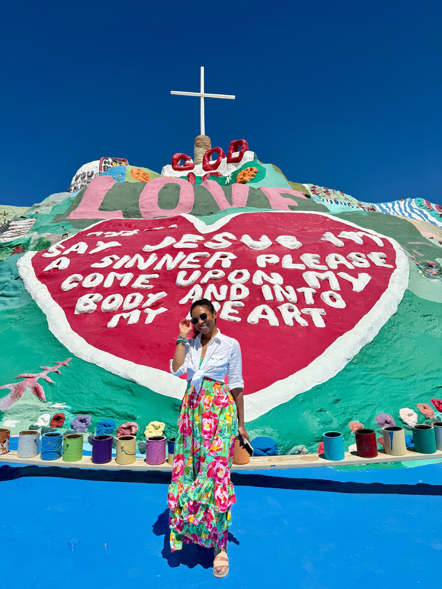 Checking out the iconic Salvation Mountain in Niland, California! Layer a button down shirt over a strapless dress to make it modest. #modestfashion #modeststyle #modestsummerfashion #modestsummerstyle 

#LTKTravel #LTKSeasonal #LTKStyleTip