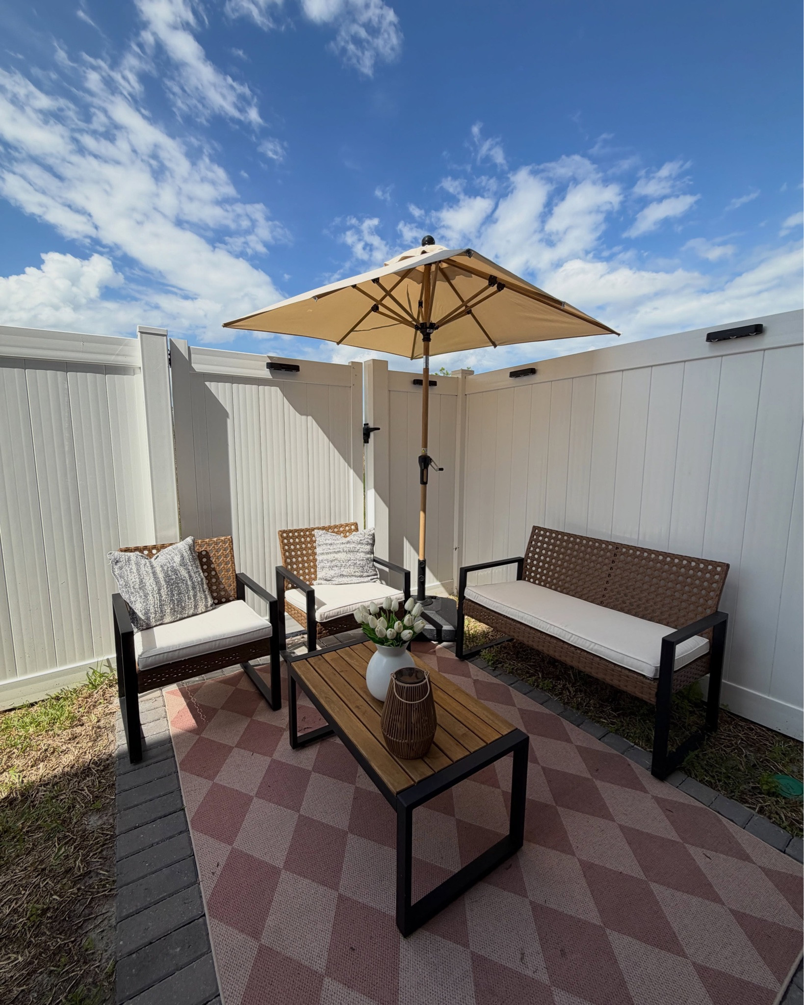 🫶🏻🌴🍸Golden hour hits different now ☀️. Love this rattan patio set ! The waterproof umbrella 6x6 . Outdoor Rug 5x7  Pillows 20x20 and covers 18x18. And beautiful solar fence lights 🫶🏻.

Comment SHOP below to receive a DM with the link to this post on my LTK ⬇ https://liketk.it/64sai 

#patio 
#cozyhomedecor 
#purpleleafpartner