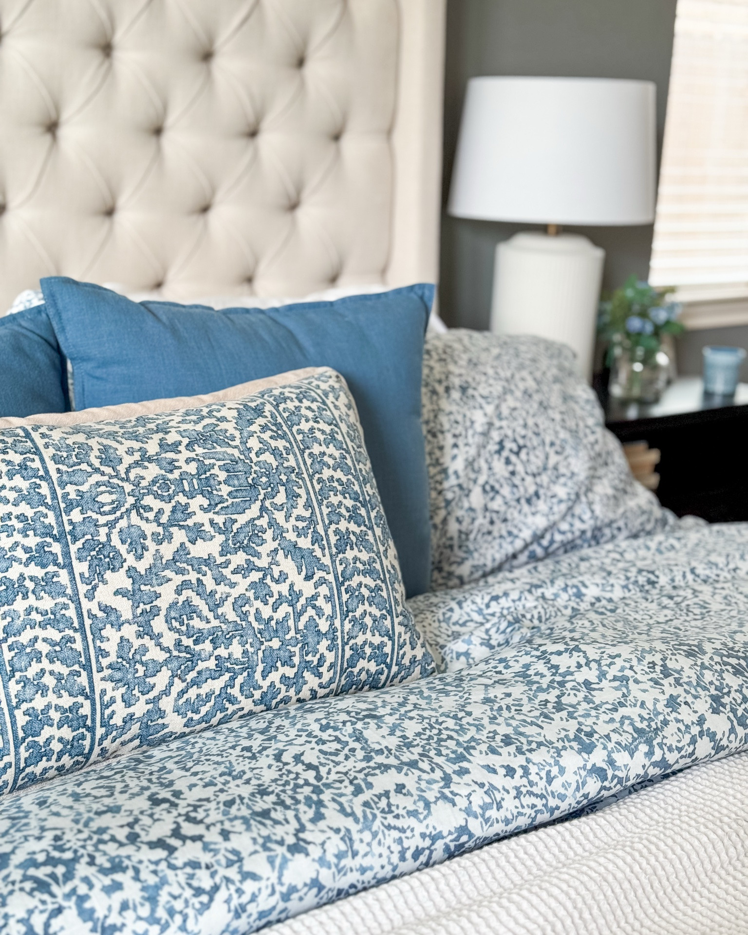 Summer bedroom refresh with blue florals. 

White lamp, black nightstand, organic cotton duvet, floral duvet, organic cotton sheets, blue floral throw pillow, blue flower arrangement

#LTKHome #LTKSeasonal
