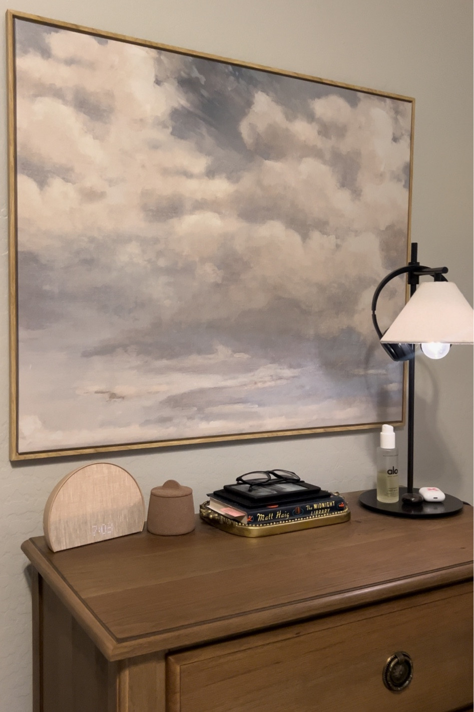 cozy bedside night table decor. Dimmable lamp, hatch alarm clock, books, and a dreamy cloud painting

#LTKhome