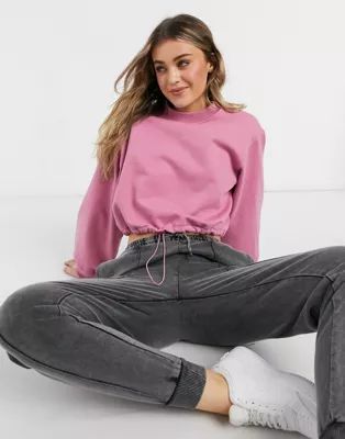 In The Style x Courtney Black activewear cropped sweatshirt with drawstring waist in pink | ASOS (Global)