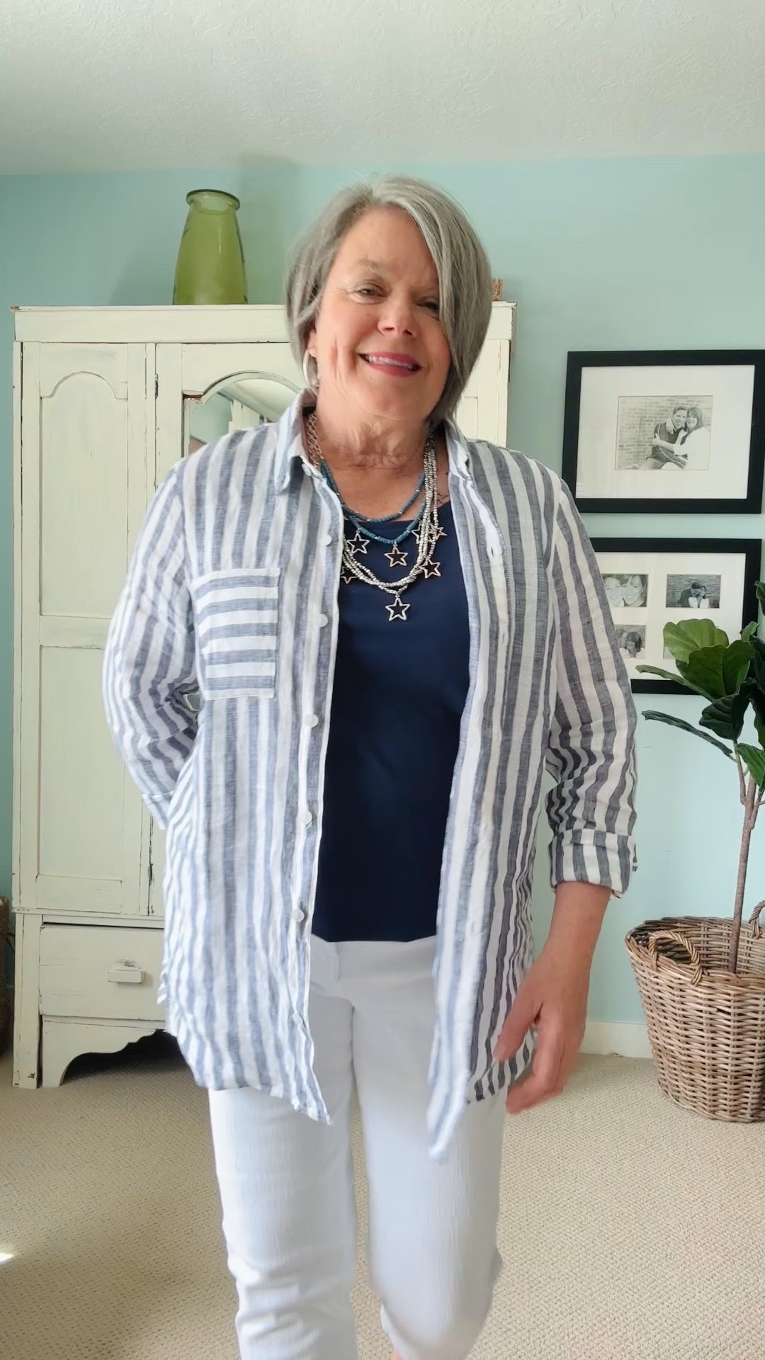 Great outfit for us gals over 50! Perfect for traveling. The beautiful long tunic striped linen shirt layered over a soft navy blue tank is comfortable for hot weather. The cropped white straight leg capris have lots of stretch in them. I sized down to a 10 in these. A fun silver and blue star necklace creates a sparkle and is perfect for your Memorial Day picnic or 4th of July party! Comfortable Minnetonka sandals in either the colorful pattern or denim complete this summer outfit! 
#earlysummeroutfit #traveloutfit

#LTKdayinmylife #LTKootd #LTKMidsize
