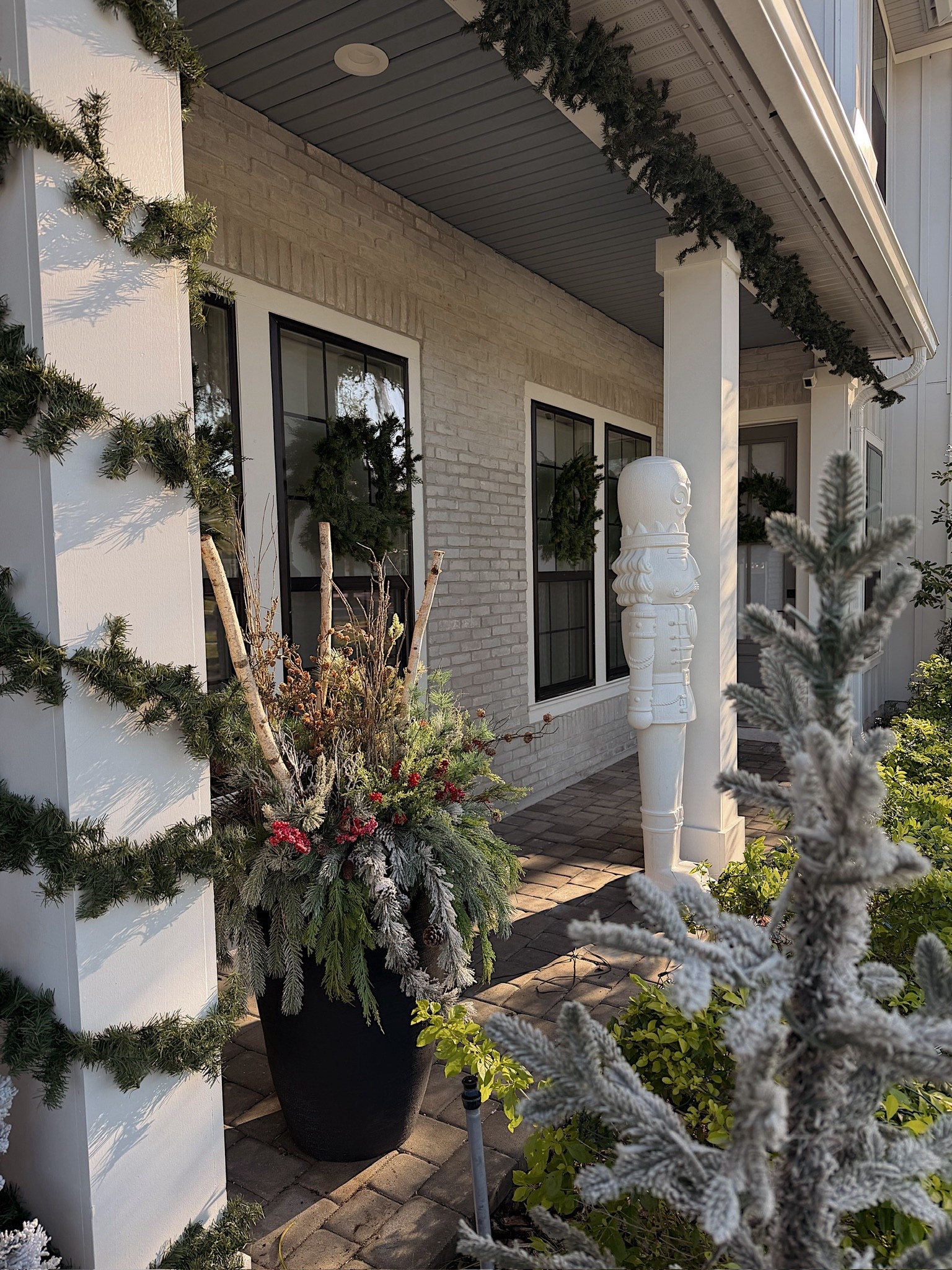 Our Christmas front porch! Lots of garland and festive planters! 

#LTKHome #LTKSeasonal #LTKHoliday
