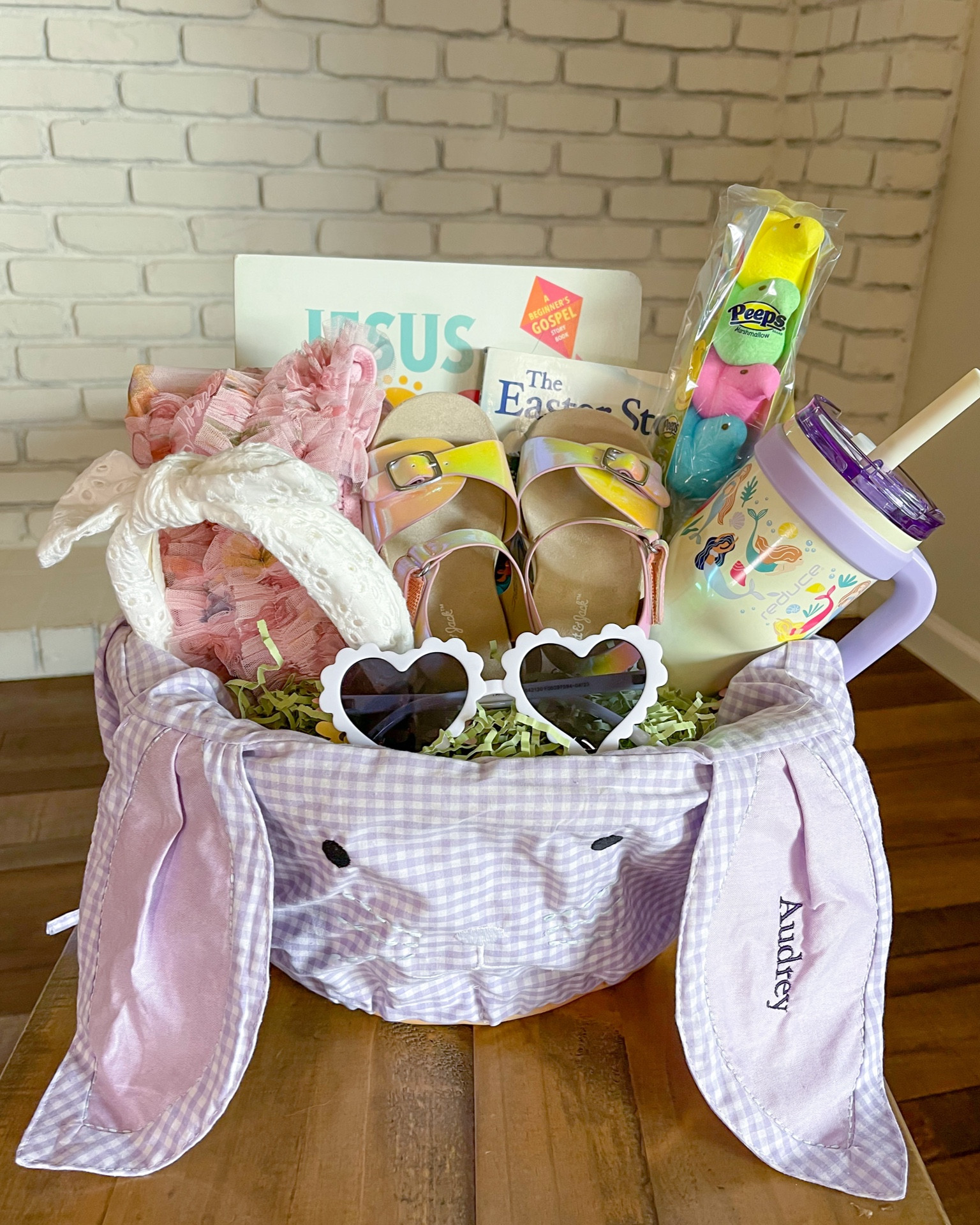 Easter basket filler ideas for kids! These personalized pottery barn basket liners are my absolute favorite! I've included Easter books, a tulle dress, stylish sandals for girls, heart shaped sunglasses, an adorable headband, and an insulated kids tumbler similar the stanley cup. 
Basket size is large. Liner size is large.
#easterbasketideas 

#LTKkids #LTKfamily #LTKSeasonal