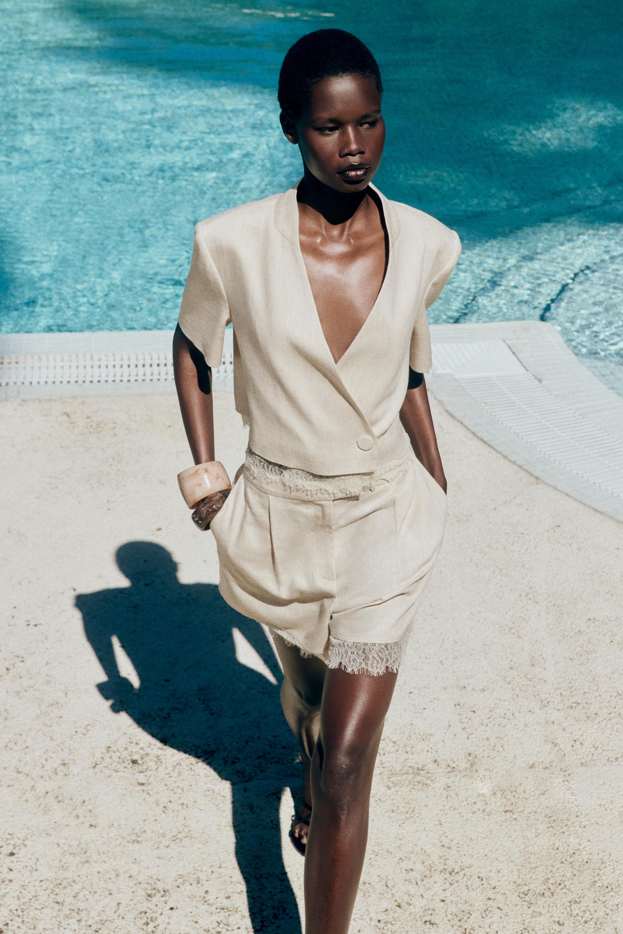 Collarless short sleeve blazer with shoulder pads. Hem finished with lace trim. Front double-brea... | Zara US
