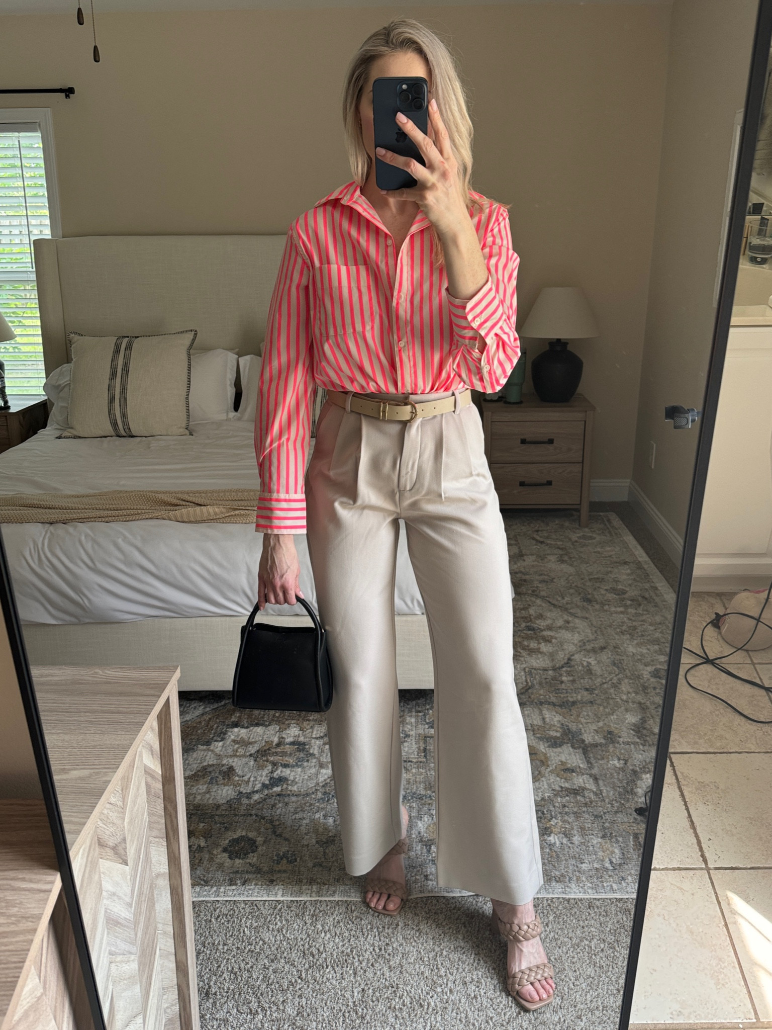 Hot pink striped button down, trouser pants, belt, heels and black handbag 