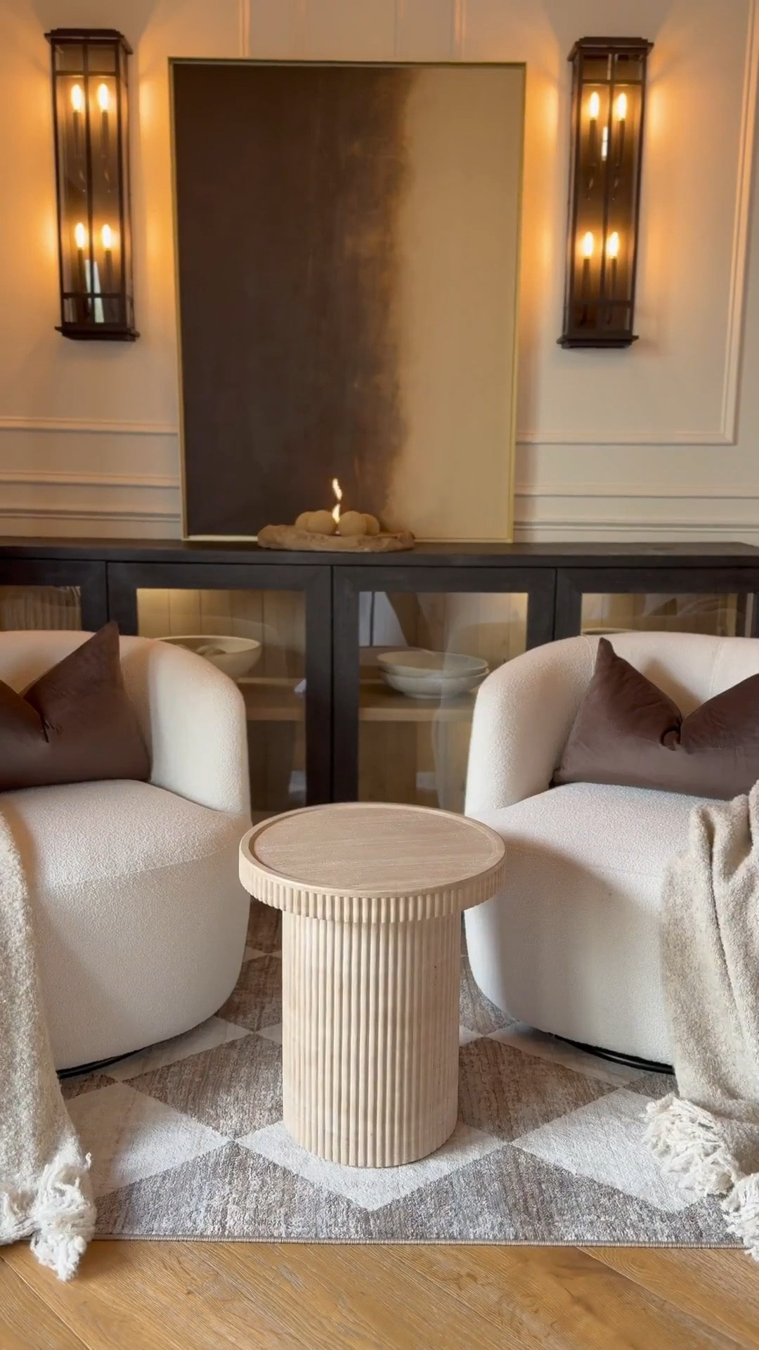 Styling this living room corner with affordable amazon finds, and I still can’t get over how beautifully it came together 🤩 simple, elegant, and so chic. All with budget‑friendly pieces that elevate the entire space.

here’s everything I used from amazon:
sideboard:

lantern sconces (set of 2)
checkered rug 5x7
decorative book
vintage‑style pot
fire‑pit balls
stone fire‑pit
velvet pillow covers
feather pillow inserts
concrete bowl
storage boxes
wireless lighting
electric lighter
fluted side table
travertine tray
modern accent chairs


cozy corner decor
warm modern style


#amazonhome #homestyling #livingroominspo #affordablehomedecor #homestyledecor #founditonamazon #moodymoderndecor #moodymodern #interiordesign #aestheticlivingroom #summerthompsonstyles

#LTKvlog #LTKdayinmylife #LTKHome