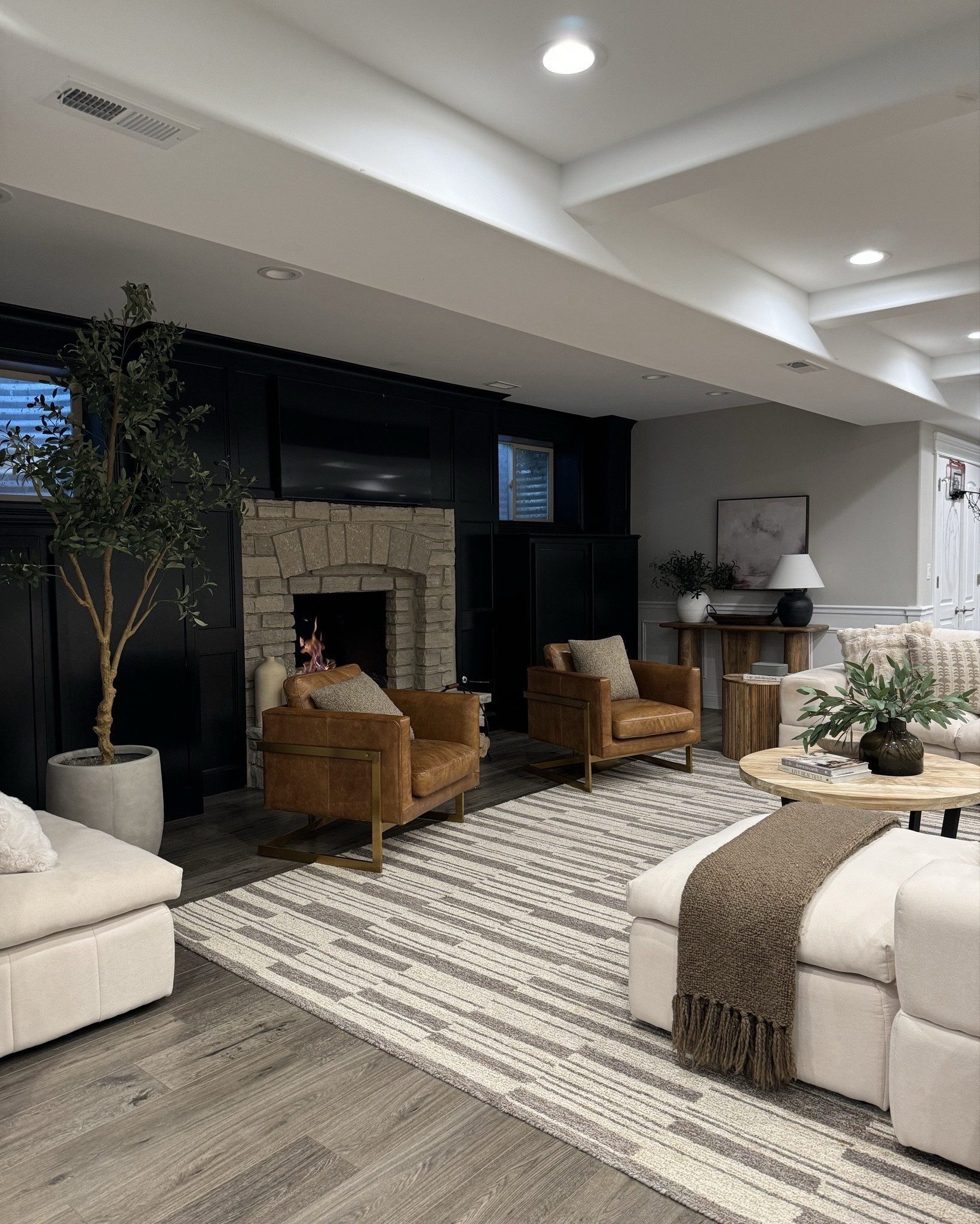 Basement cozy views! Chairs are Edloe and Finch, and coffee table is from Article and cannot be linked. Rug is on sale, and my faux olive tree and favorite designer inspired planter. 

#LTKSaleAlert #LTKHome #LTKxWayfair